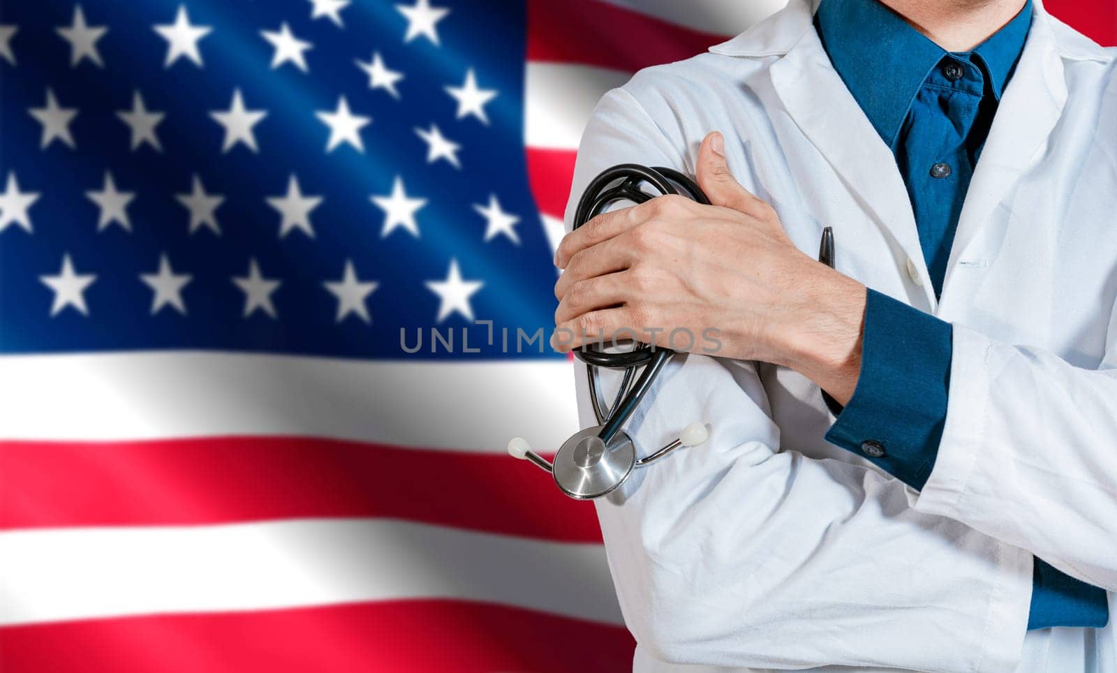 Doctor with stethoscope on USA flag. Health and care with the flag of United State. USA national health concept, Doctor arm holding stethoscope on USA flag