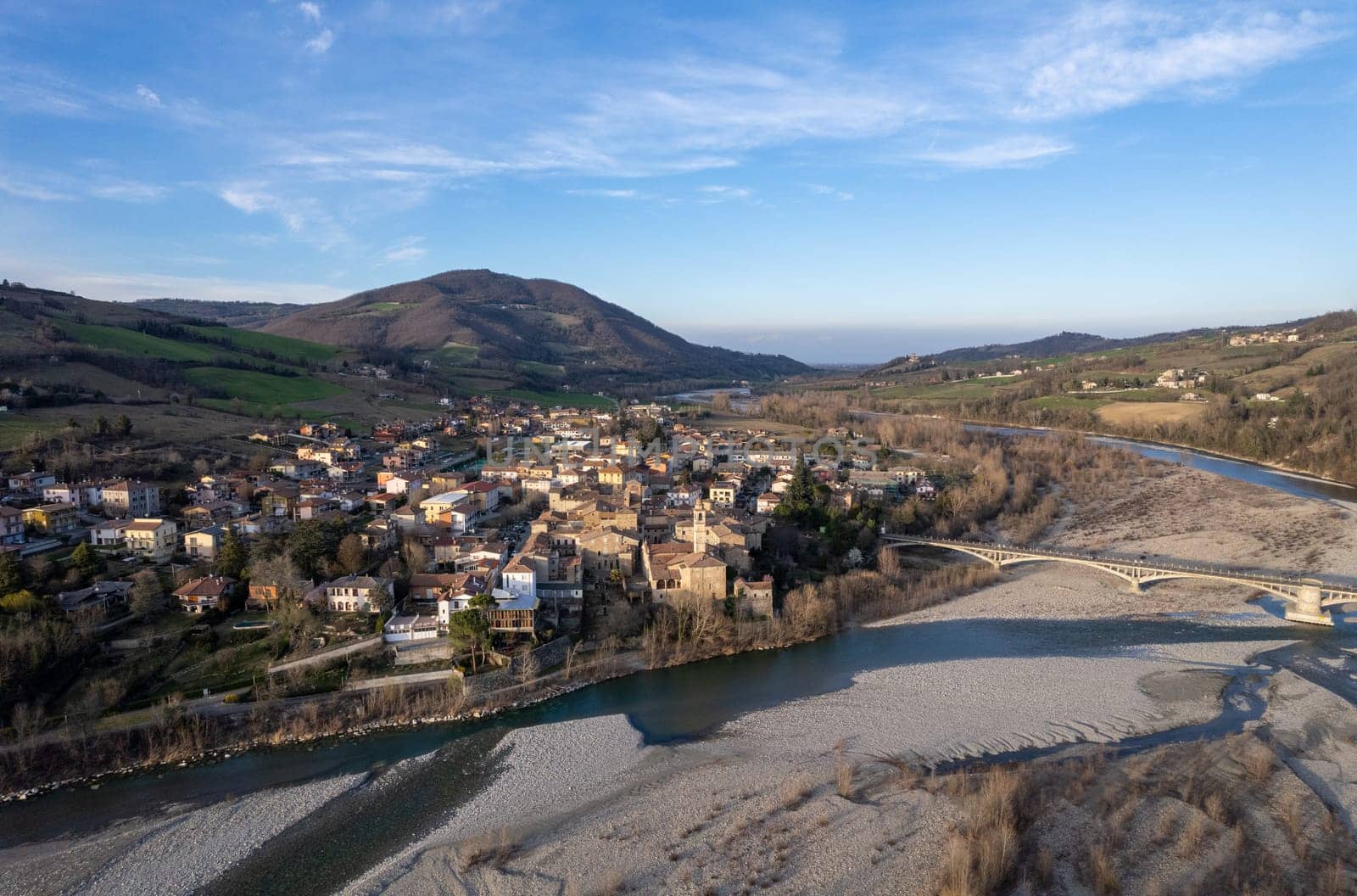 Aerial scenic view of Travo Village, Trebbia river, Valley landscape, Piacenza Italy at sunset