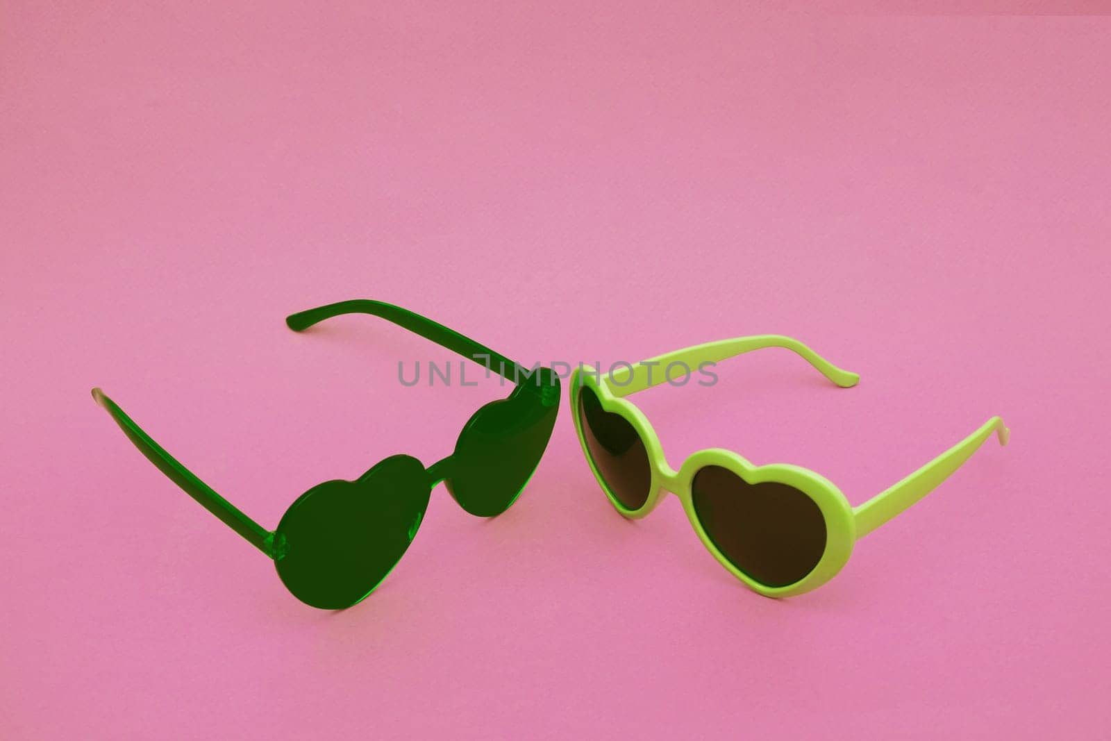 Two sunglasses on a pink background. by gelog67