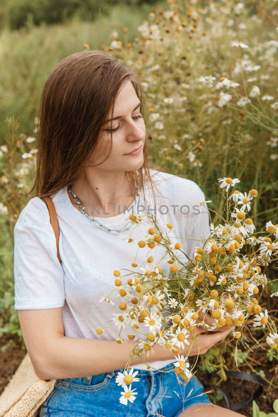 Beautiful young woman in nature with a bouquet of daisies. Field daisies, field of flowers. by Annu1tochka