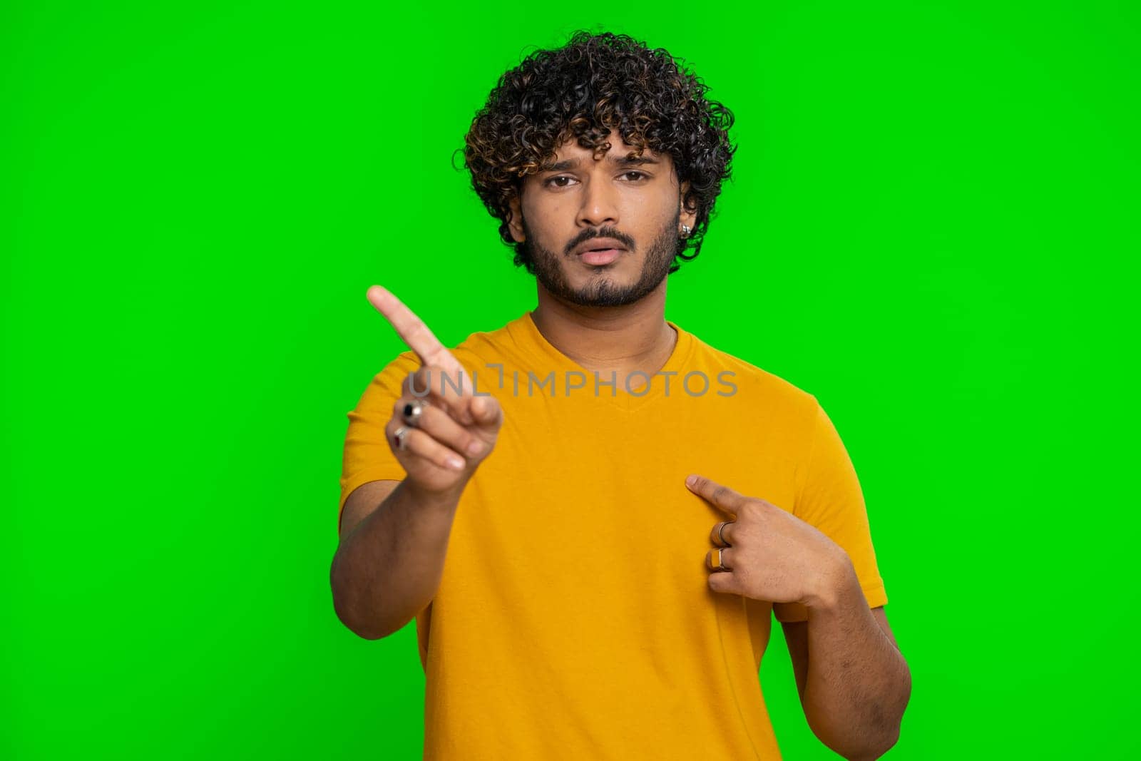 I am dont want it, not me. Confused young indian man pointing fingers hisself ask say who why me no thanks i do not need it, rejection, refusal, stop sign. Hindu guy isolated on chroma key background