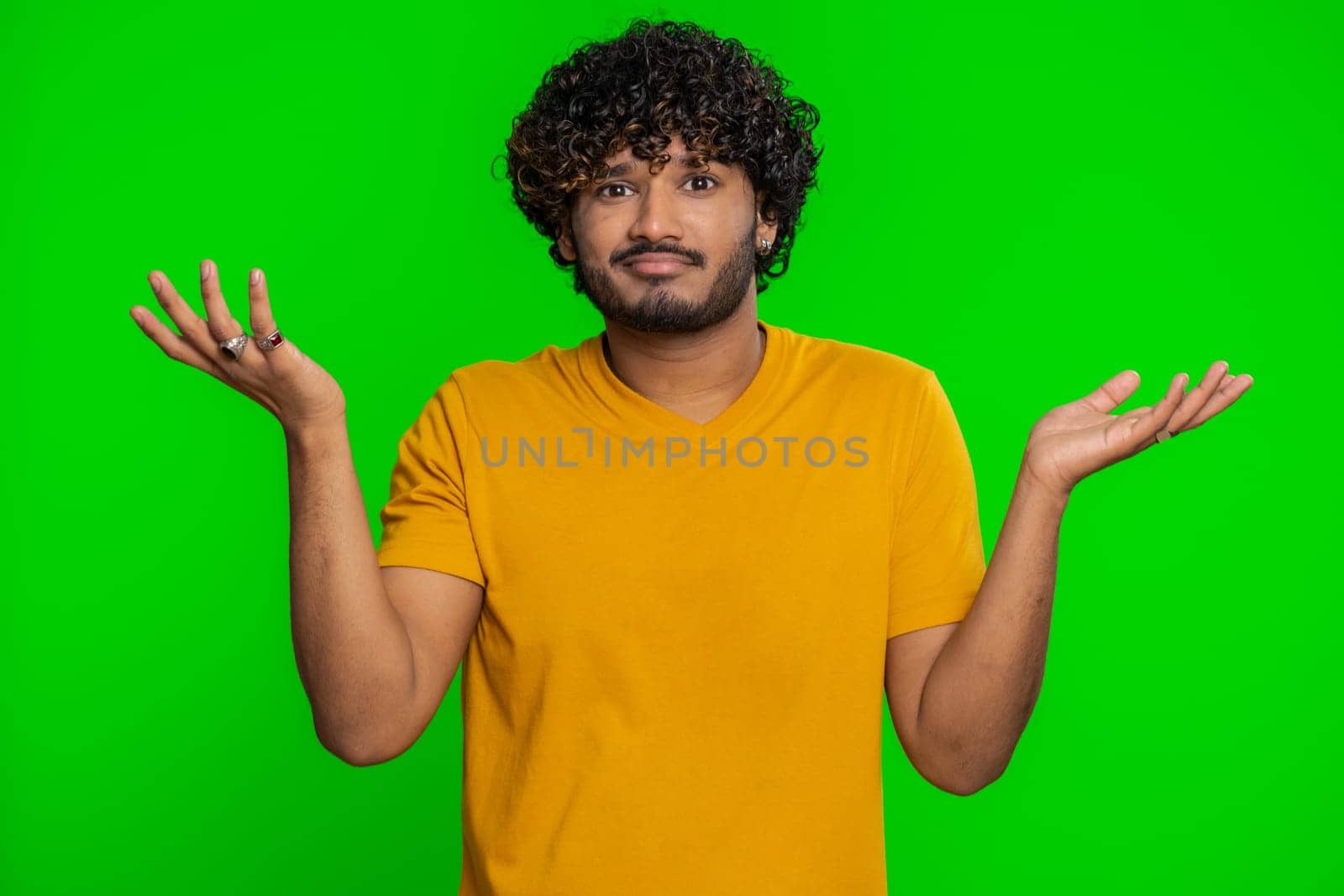No idea, I dont know answer. Puzzled clueless uncertain indian handsome man raising hands in helpless gesture, embarrassed confused by difficult question. Confused one guy on chroma key background