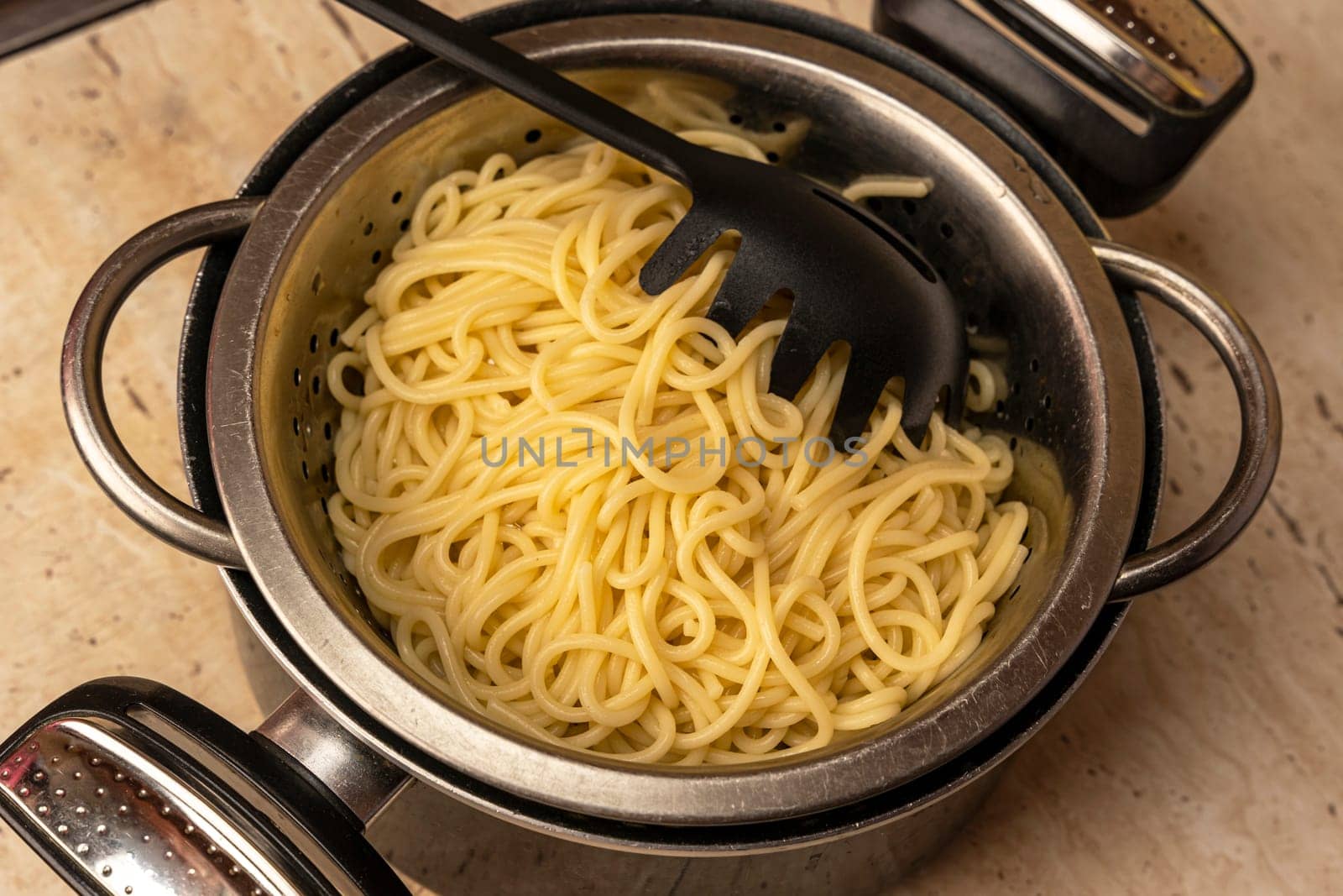 boiled ready-made spaghetti in a colander and a kitchen saucepan by audiznam2609