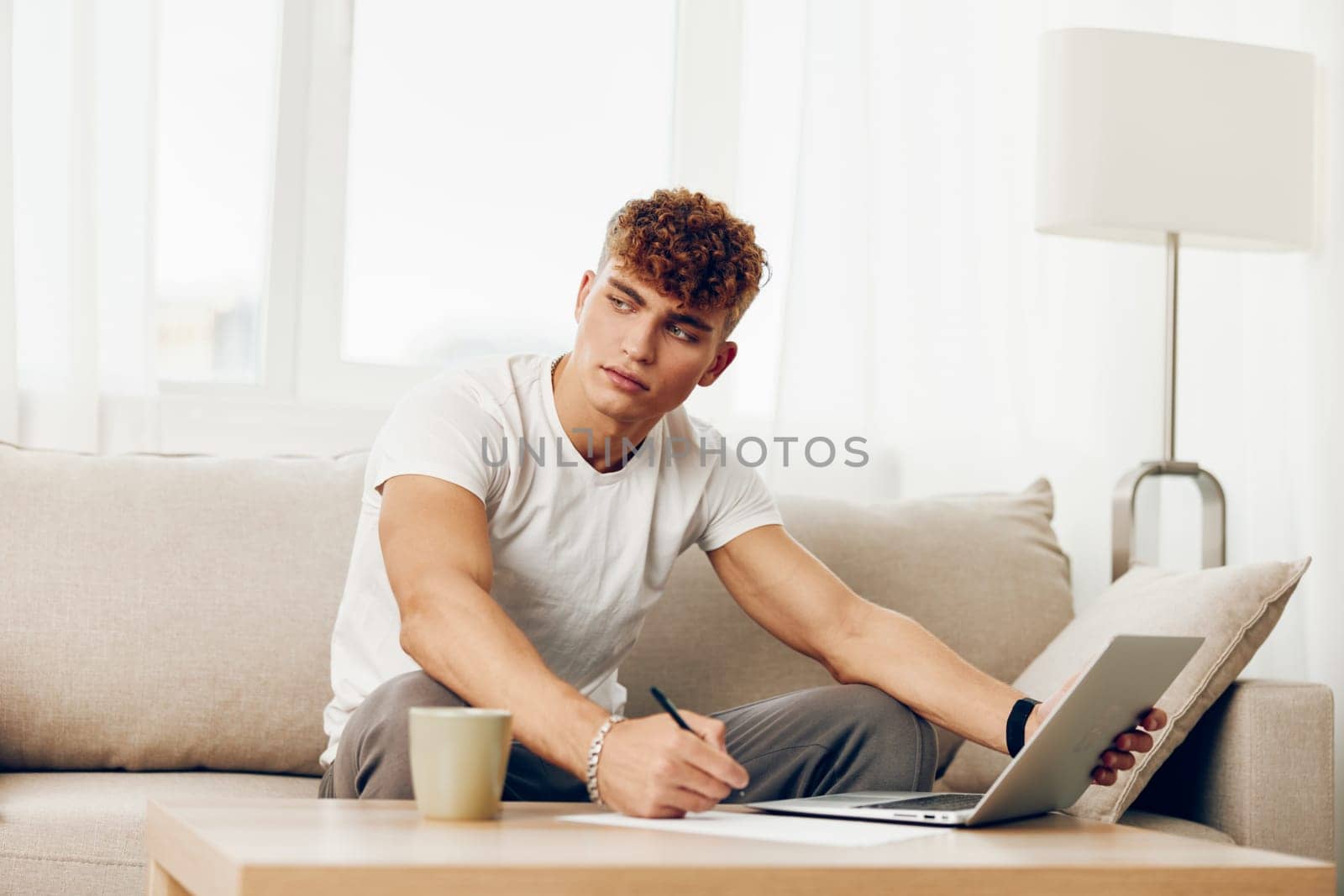 man interior typing caucasian laptop lifestyle home happy adult chat sitting cup using student curly computer person business