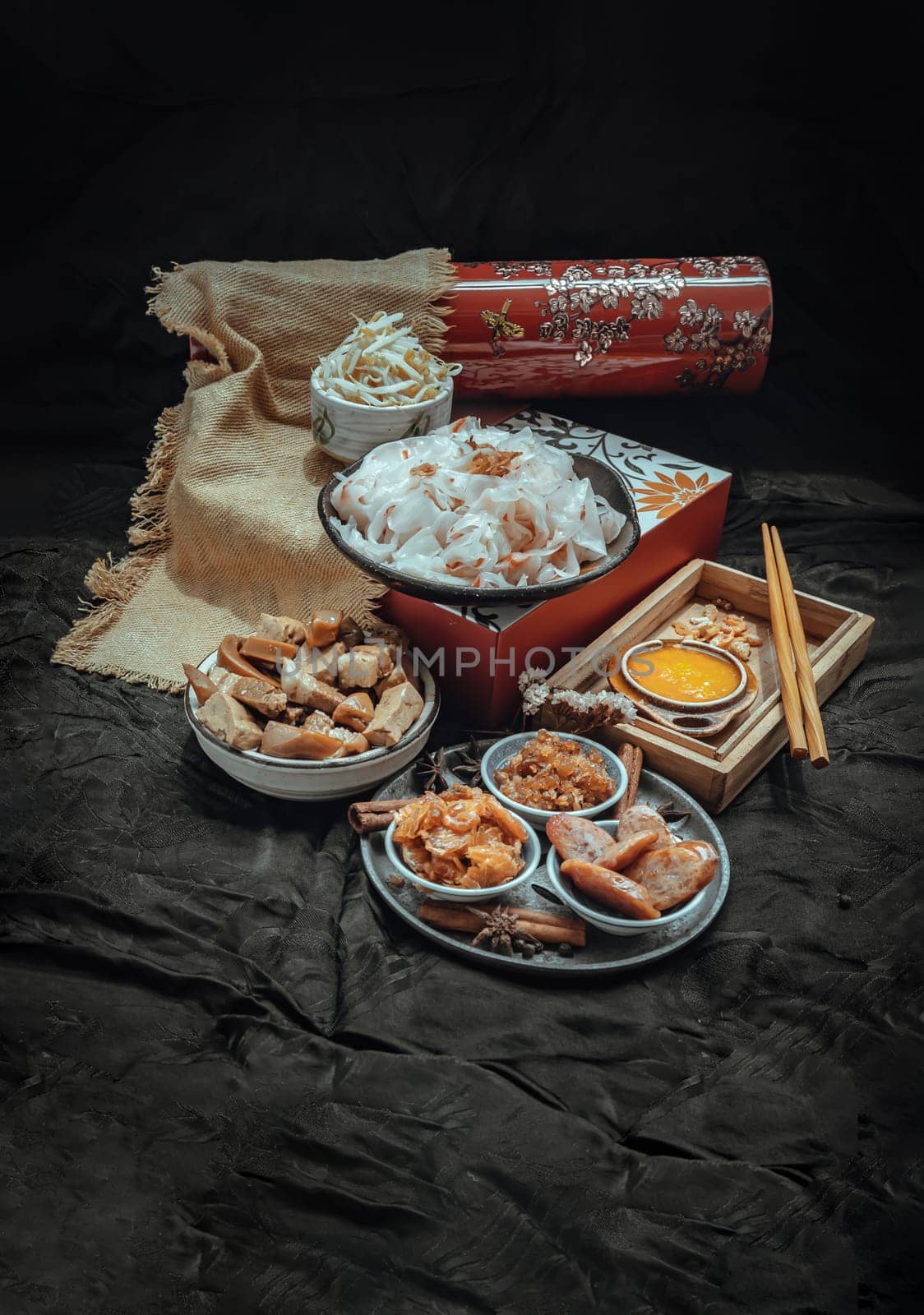 Chinese steamed flat wide rice noodles with Braised pork, Tofu, Crisp squid in sweet soy sauce and Bean sprout, Chinese sausage sliced, Fried dried shrimp and Pickle turnip serve with pickled chili. Asian food style, Space for text, Selective focus.