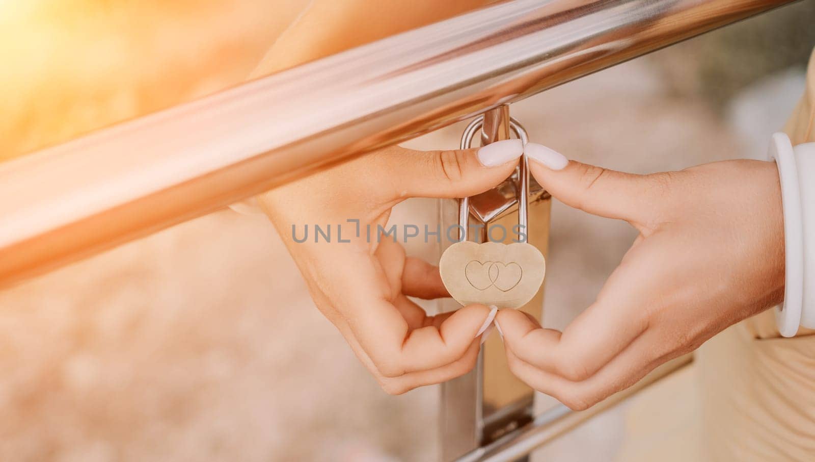 Hands, lock, heart, love, valentines day. Close-up of a woman's hands holding heart shaped padlock with a heart. The concept of Valentine's day, wedding, symbol of love and fidelity. by panophotograph