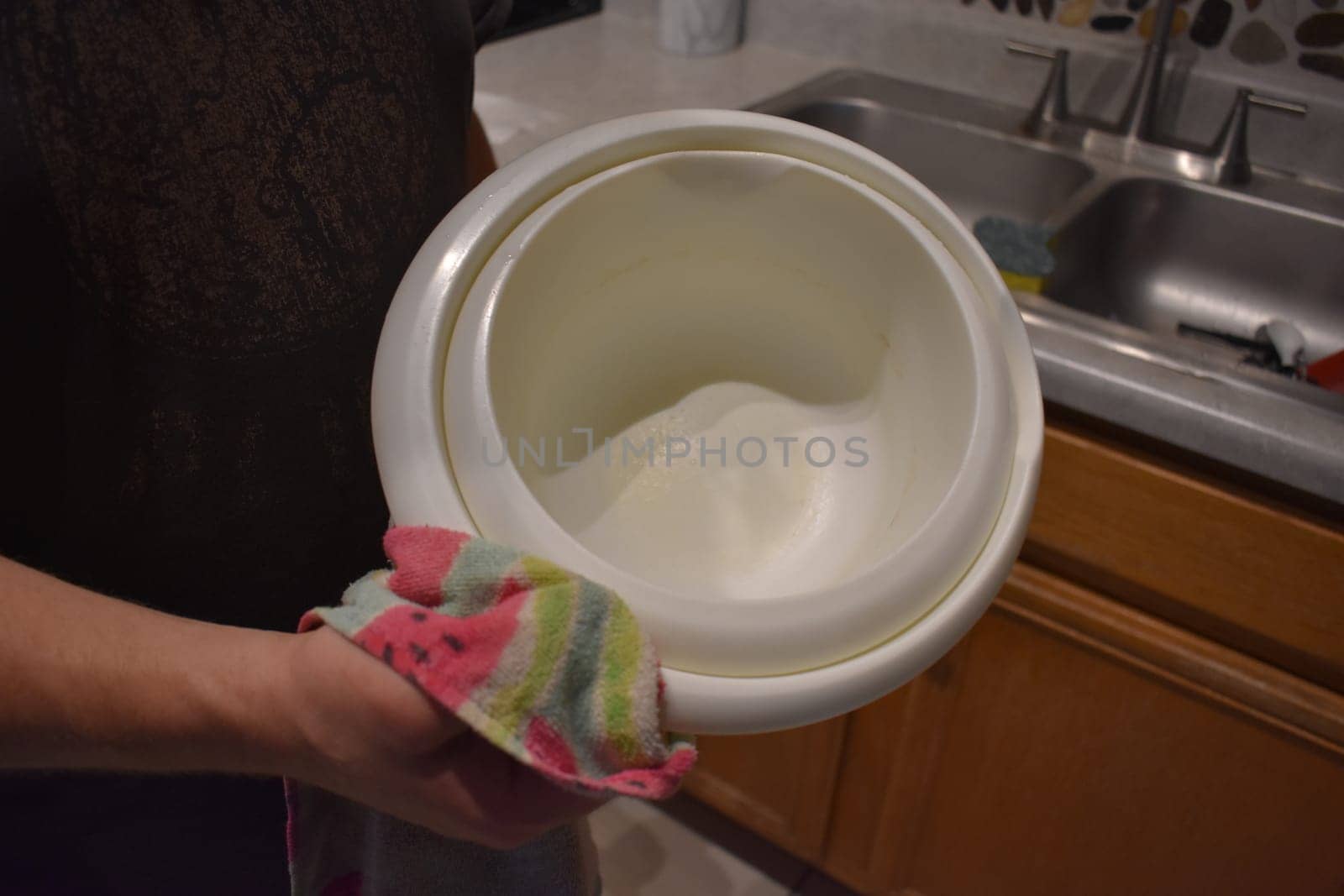 Drying Dishes by Hand with Towel in Kitchen at Home. High quality photo