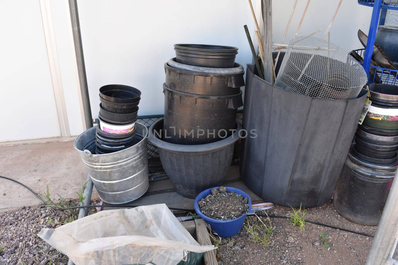 Stacked Plastic Gardening Pots for Plants in Backyard in Arizona . High quality photo