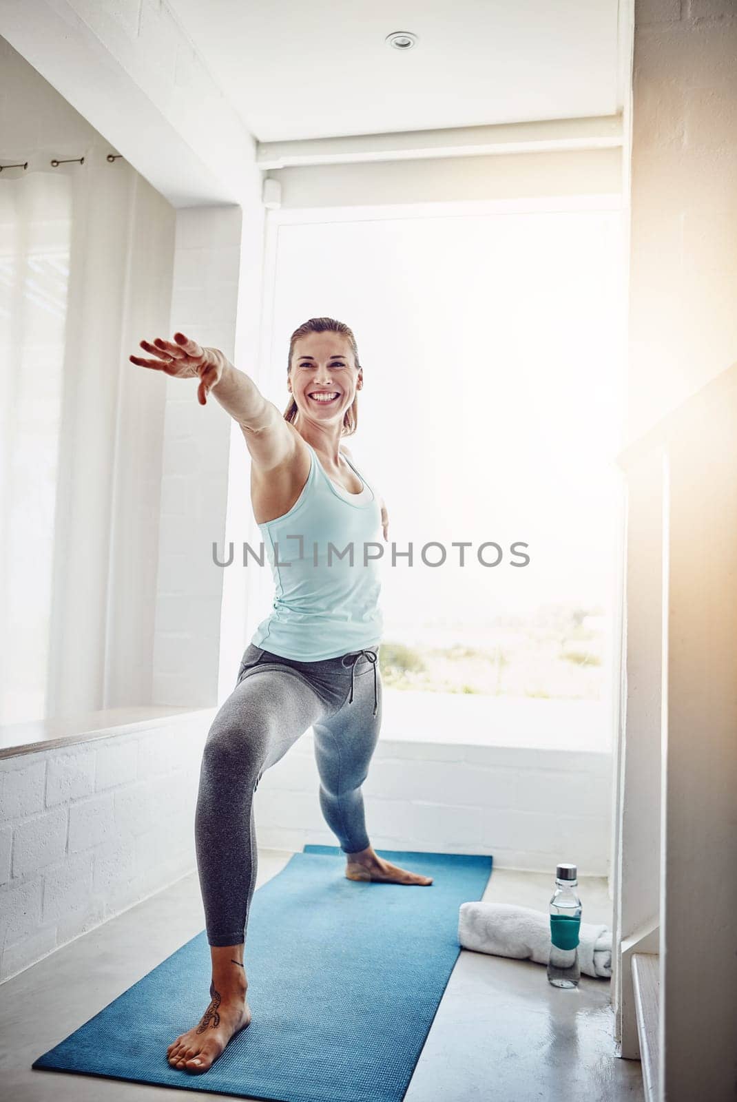 Yoga is not to be performed, its to be lived. an attractive woman practising her yoga routine at home. by YuriArcurs