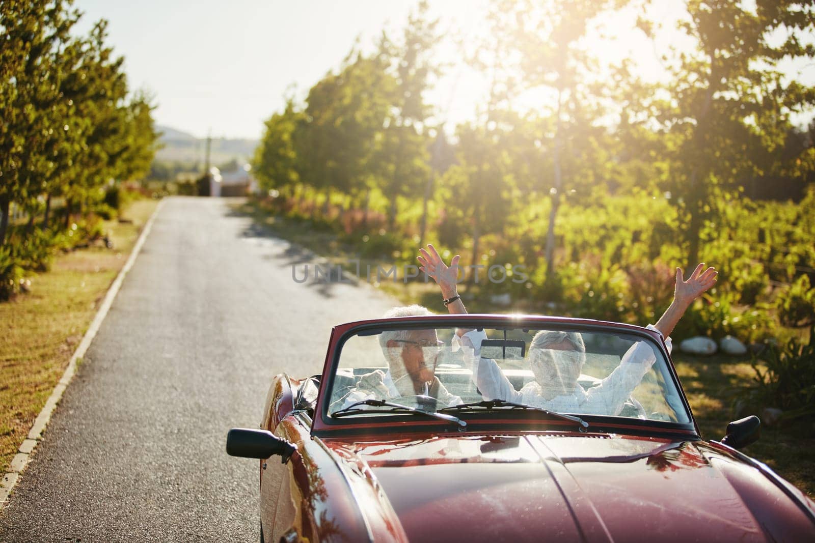 Retirement gives you a great opportunity to travel more. a senior couple going on a road trip. by YuriArcurs