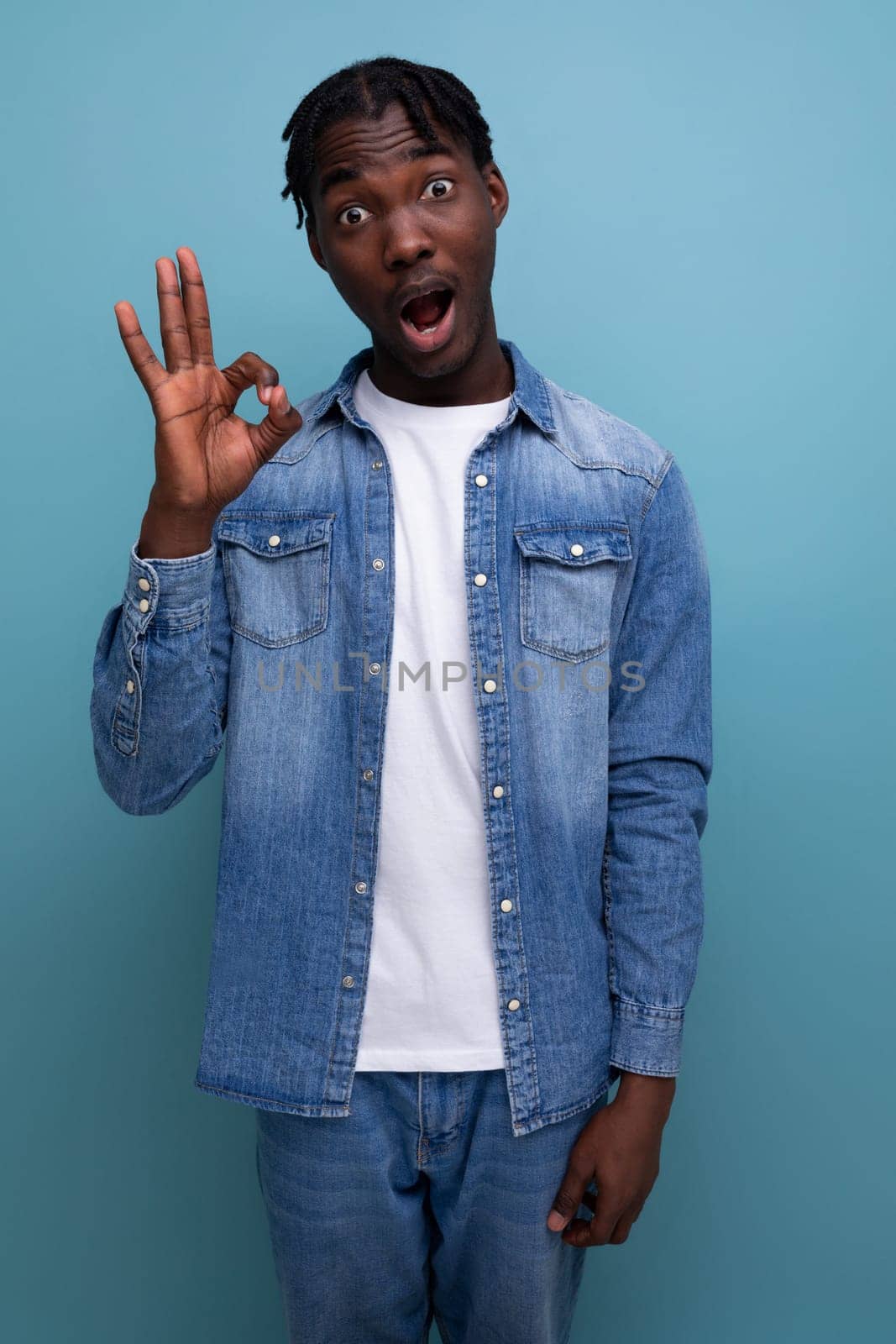 handsome african man with curly hair in denim jacket.