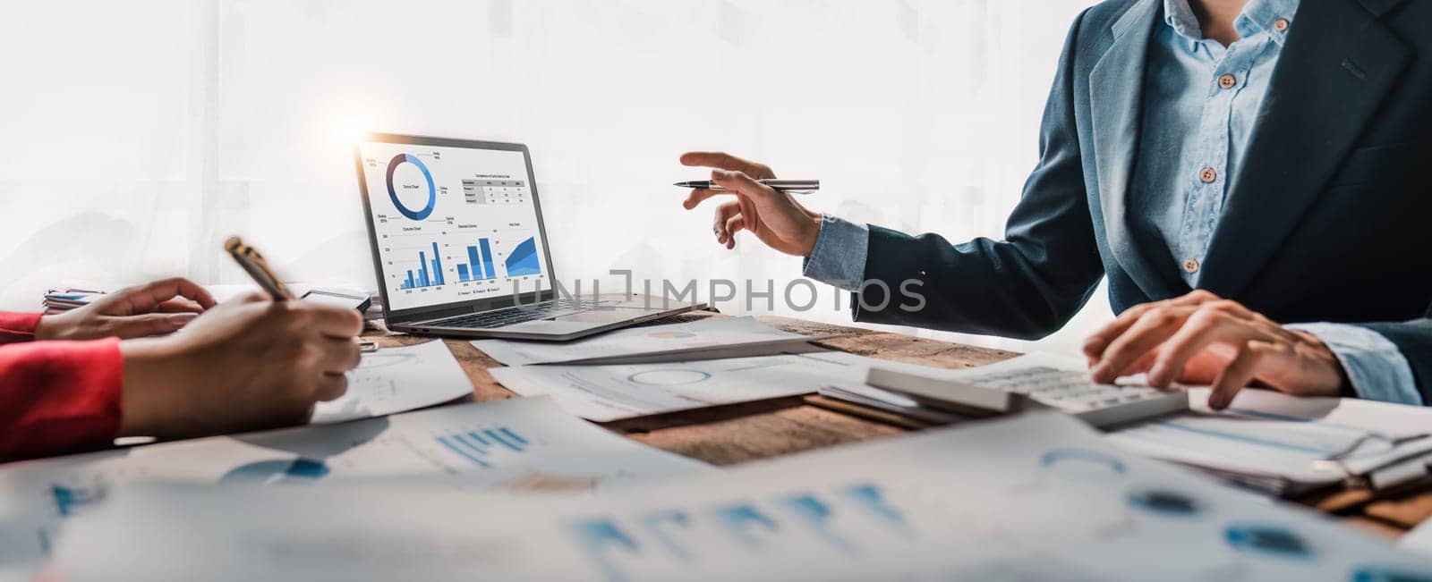 Business People Meeting using laptop computer,calculator,notebook,stock market chart paper for analysis Plans to improve quality next month. Conference Discussion Corporate Concept