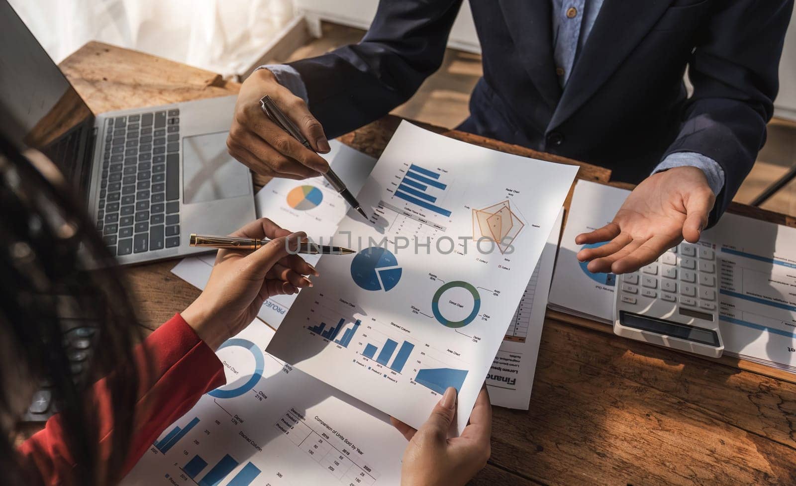 Business People Meeting using laptop computer,calculator,notebook,stock market chart paper for analysis Plans to improve quality next month. Conference Discussion Corporate Concept. by wichayada