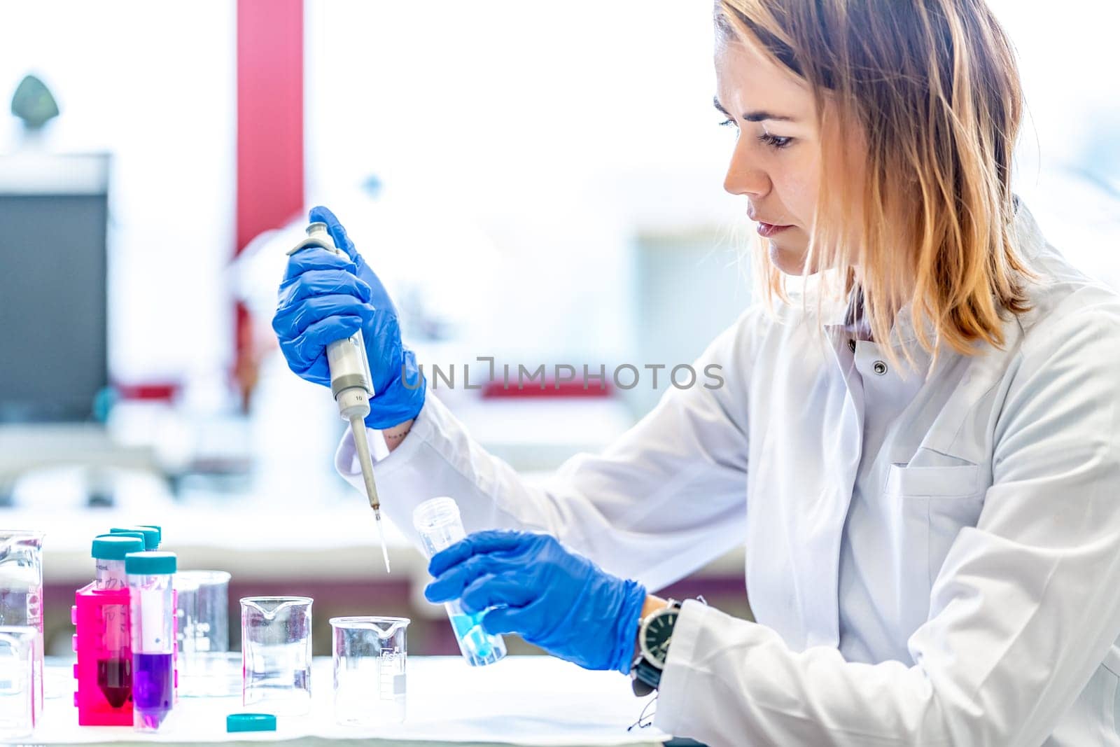 mixing of chemical substances by a young female scientist in a university research laboratory. development of new drugs and products.