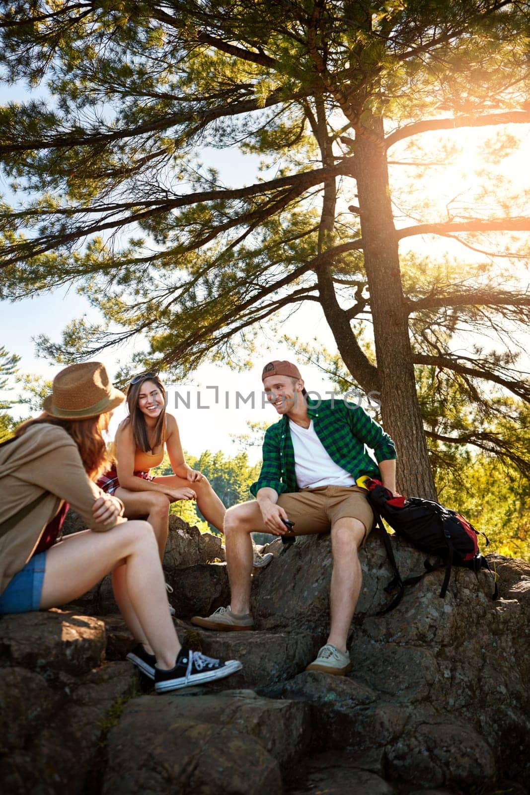 When you travel, take the scenic route. three young people hiking while on an overseas trip. by YuriArcurs