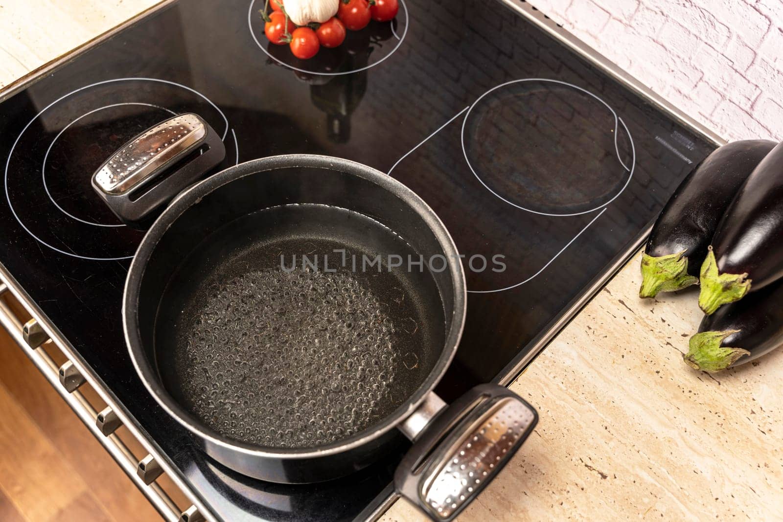 a pot of boiling water on an electric stove in the kitchen by audiznam2609