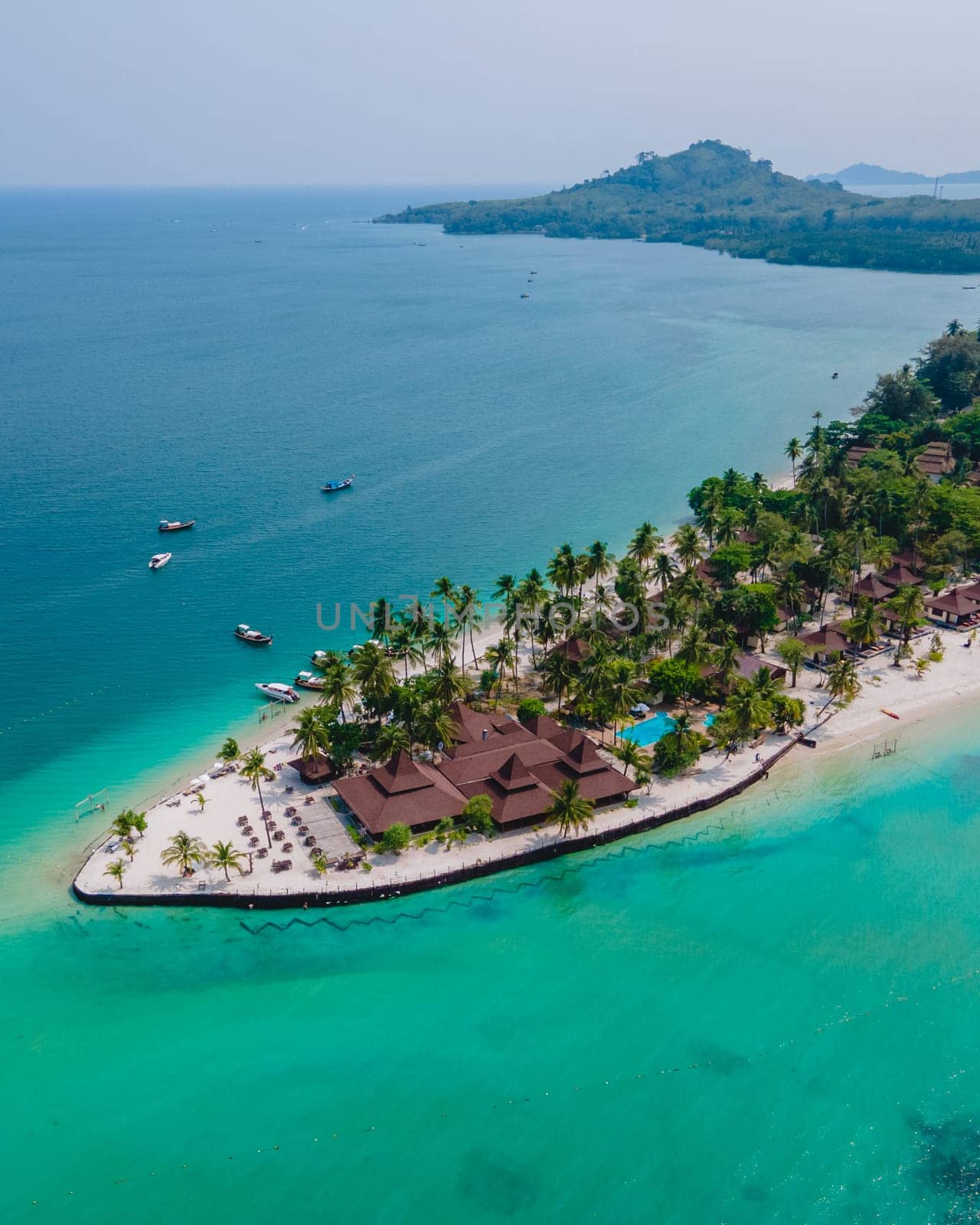 Koh Mook tropical Island in the Andaman Sea in Thailand, tropical beach with white sand and turqouse colored ocean with coconut palm trees.