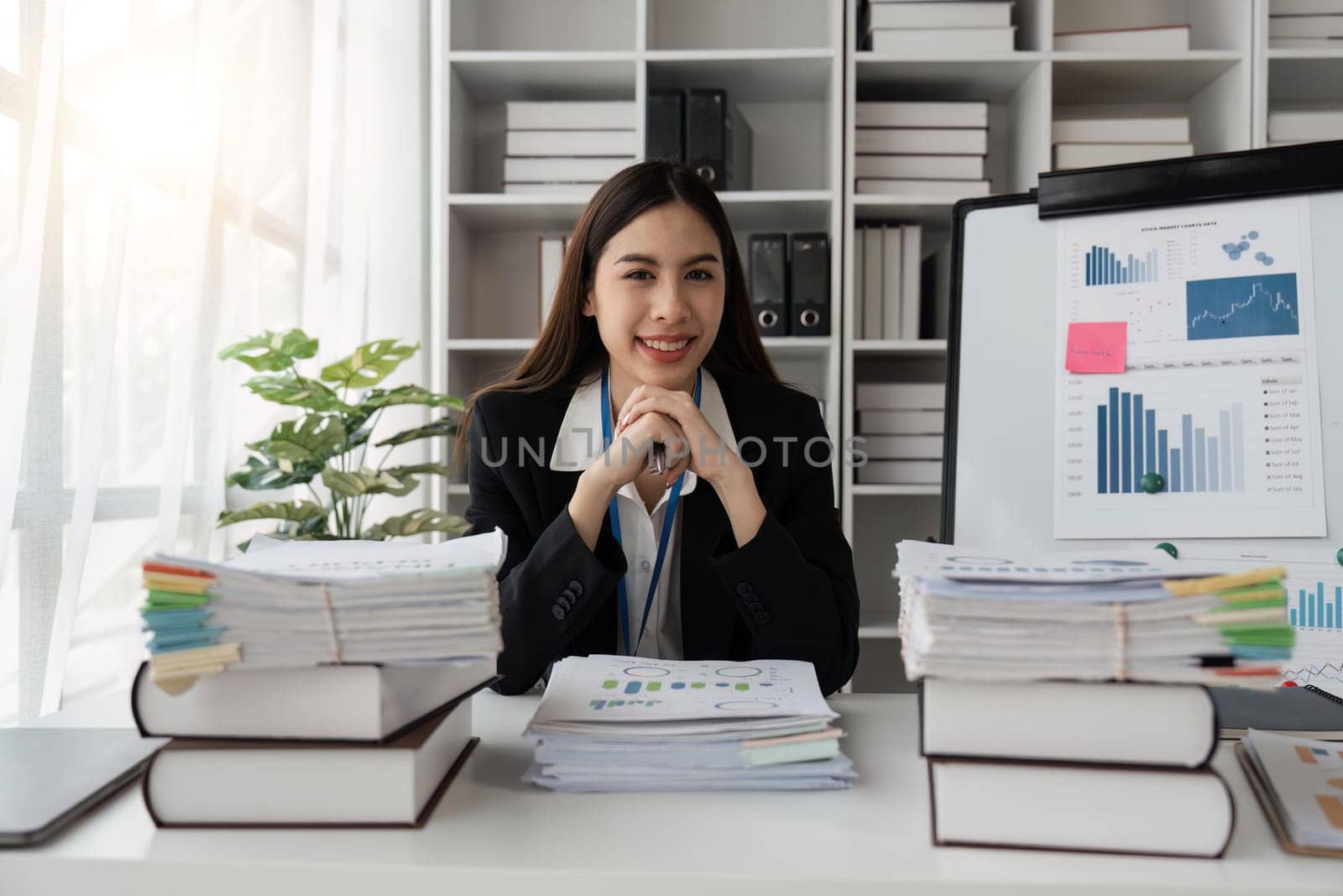 Happy business lady using laptop smiling to camera posing working sitting at workplace In office. successful entrepreneurship and career concept by nateemee