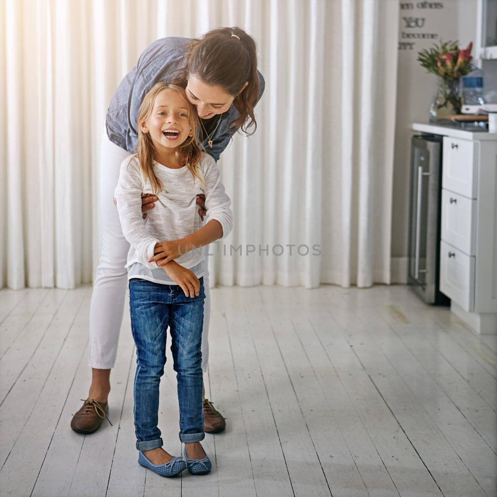 I got you. a mother and her daughter spending quality time at home. by YuriArcurs