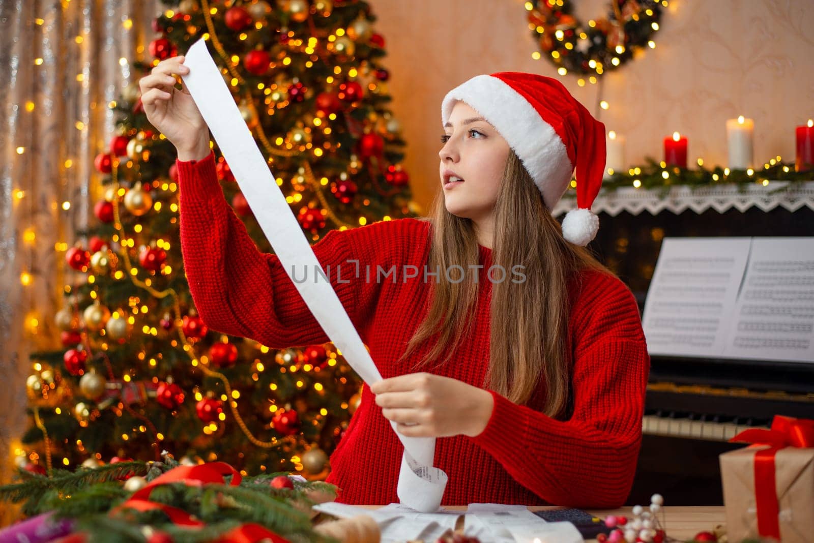 Young blong woman checks her purchaces, sitting in a beautifully decorated room