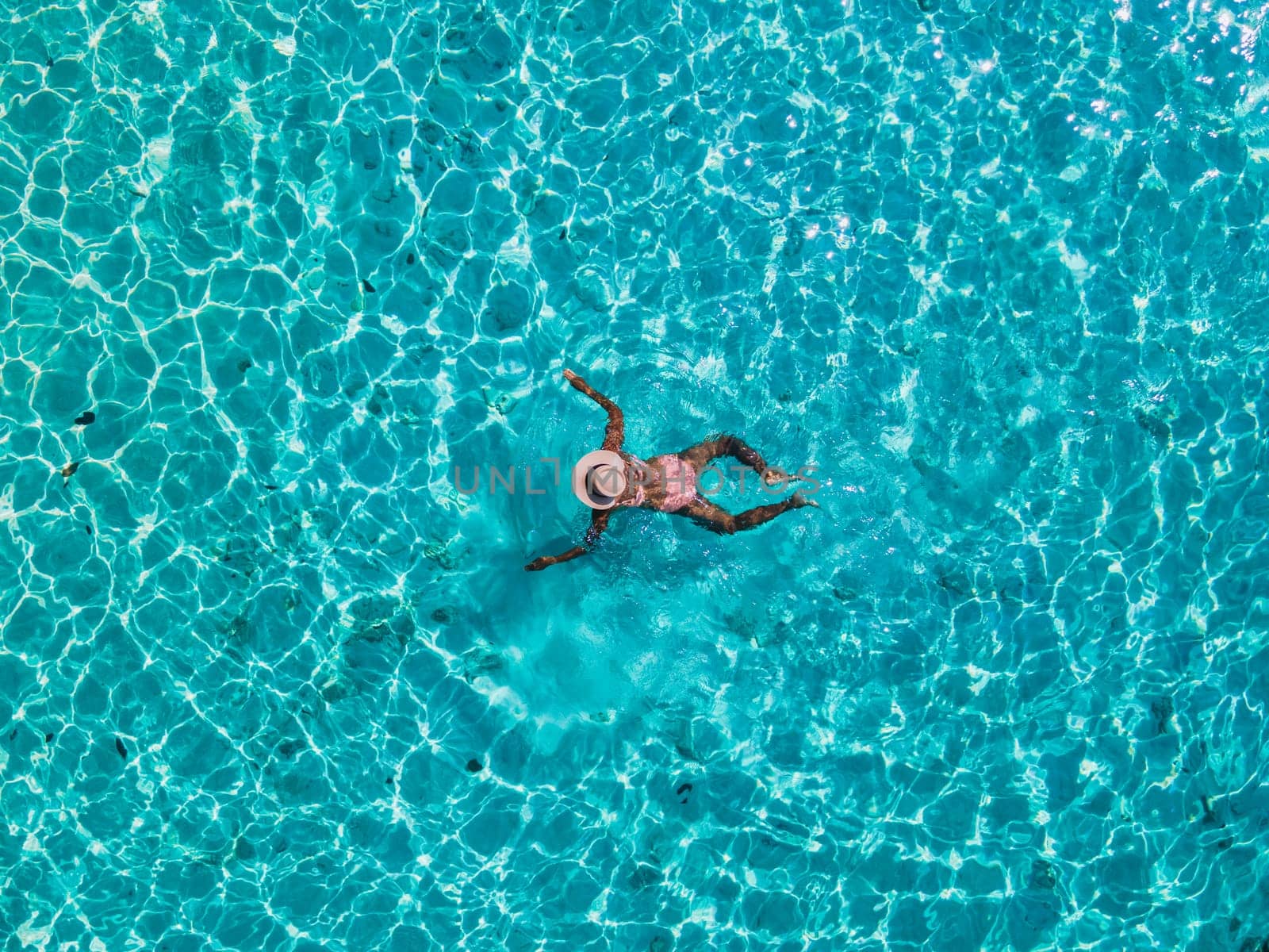 a women swimming in the ocean of of Koh Kradan Island in Thailand by fokkebok