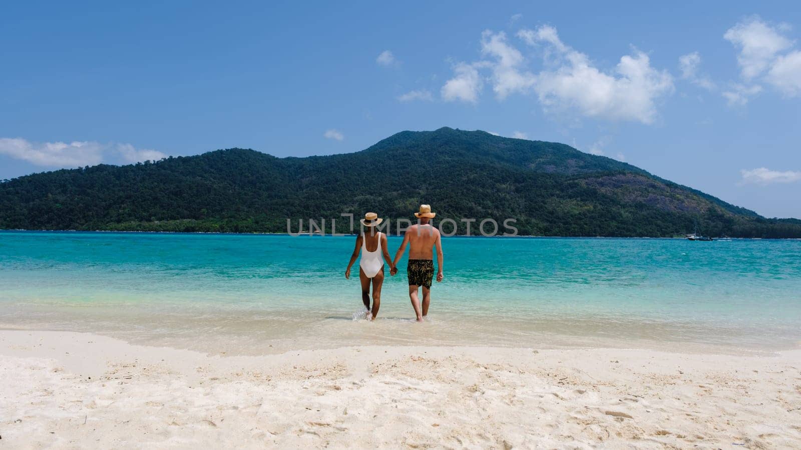 Couple on the beach of Koh Lipe Island Thailand, tropical Island with a blue ocean and white soft sand by fokkebok