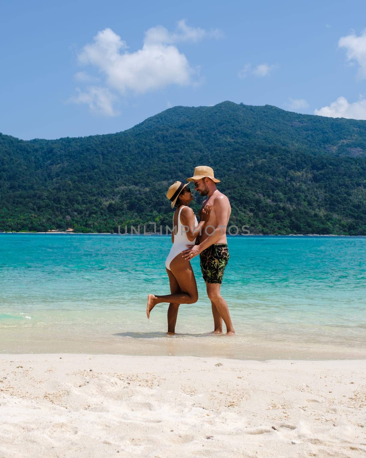 Couple on the beach of Koh Lipe Island Thailand, tropical Island with a blue ocean and white soft sand by fokkebok