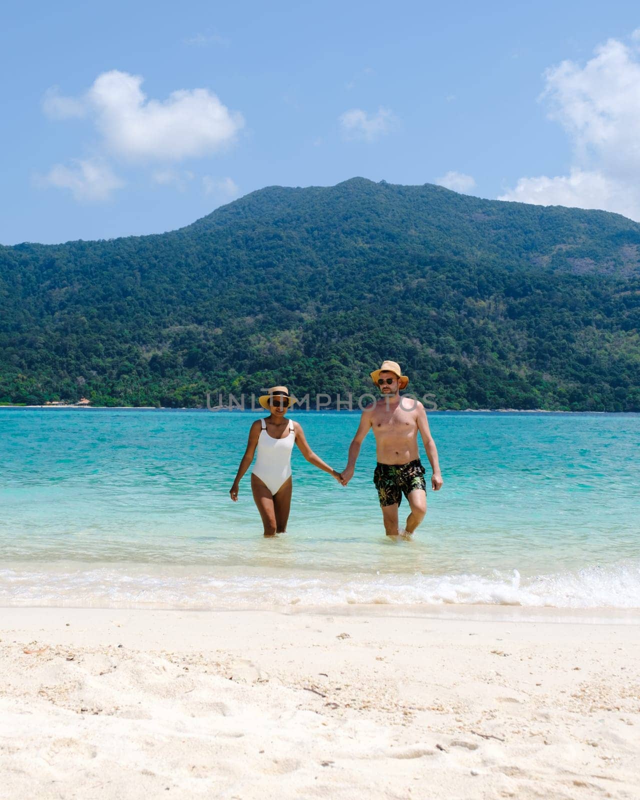 Couple on the beach of Koh Lipe Island Thailand, tropical Island with a blue ocean and white soft sand by fokkebok