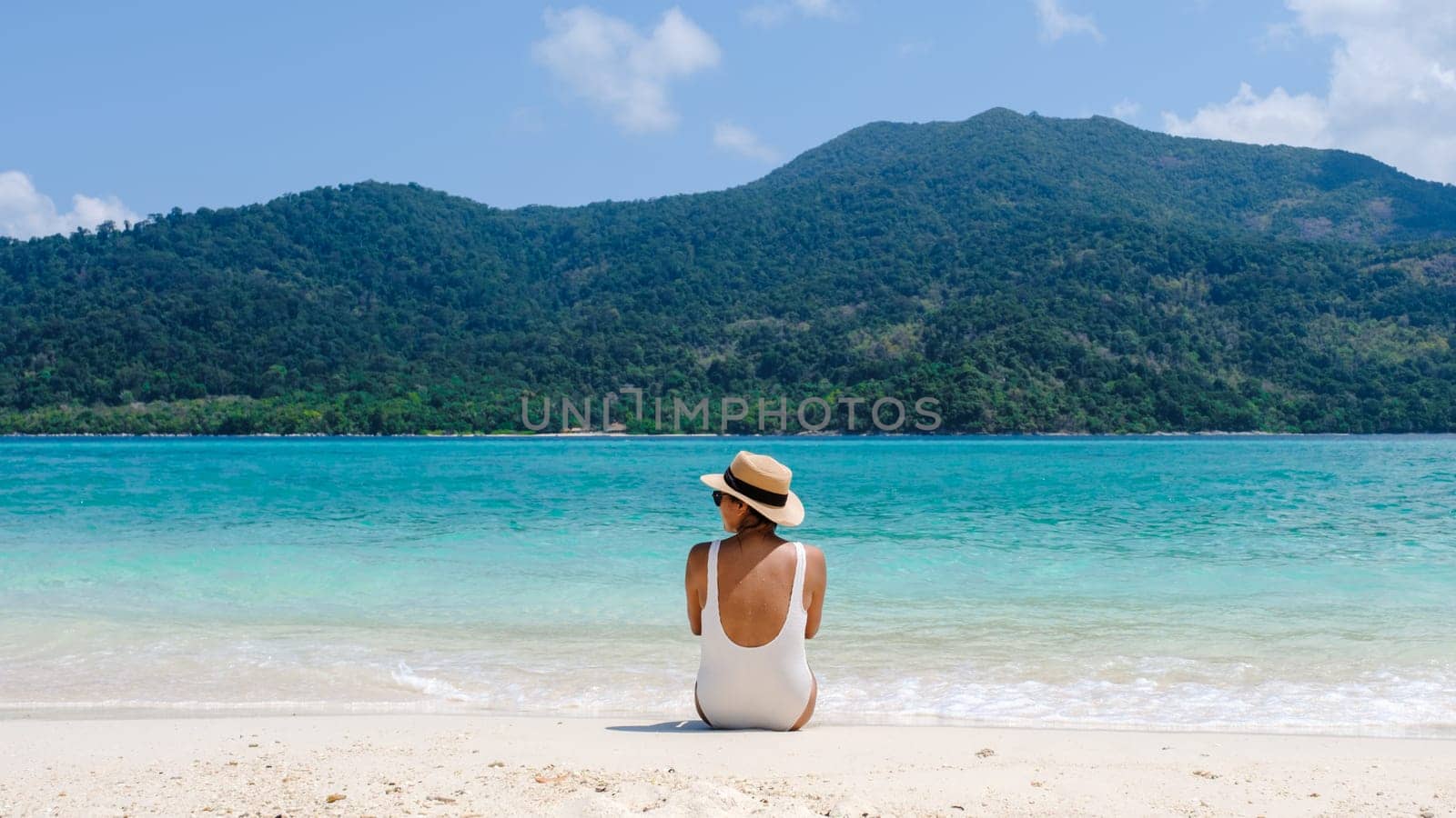 Asia women on vacation at Koh Lipe Island Thailand, a tropical Island with a blue ocean and white soft sand. Ko Lipe Island Thailand