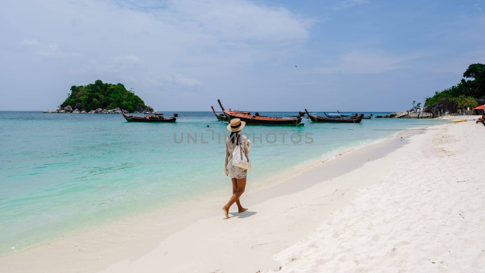 Asia women on vacation at Koh Lipe Island Thailand, a tropical Island with a blue ocean and white soft sand. Ko Lipe Island Thailand