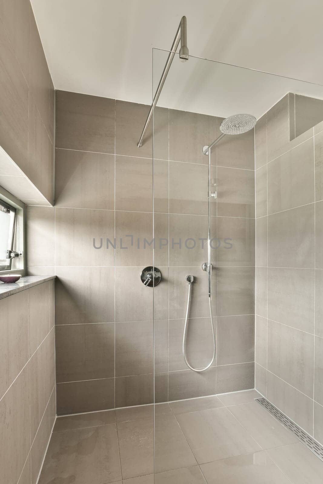 a wet room with a shower and a sink by casamedia