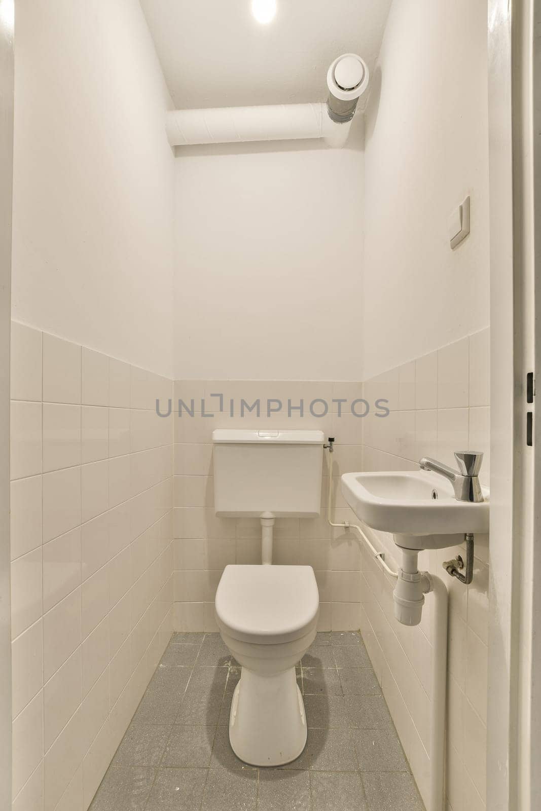 a small bathroom with a toilet and a sink by casamedia