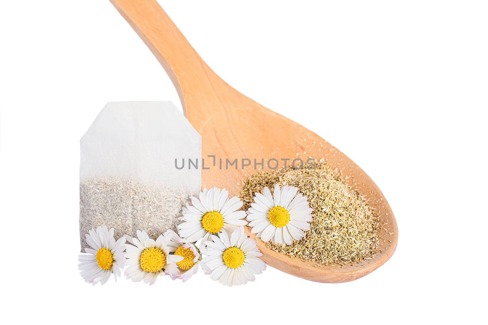 Dry chamomile tea flower petals in wooden spoon isolated on white background.