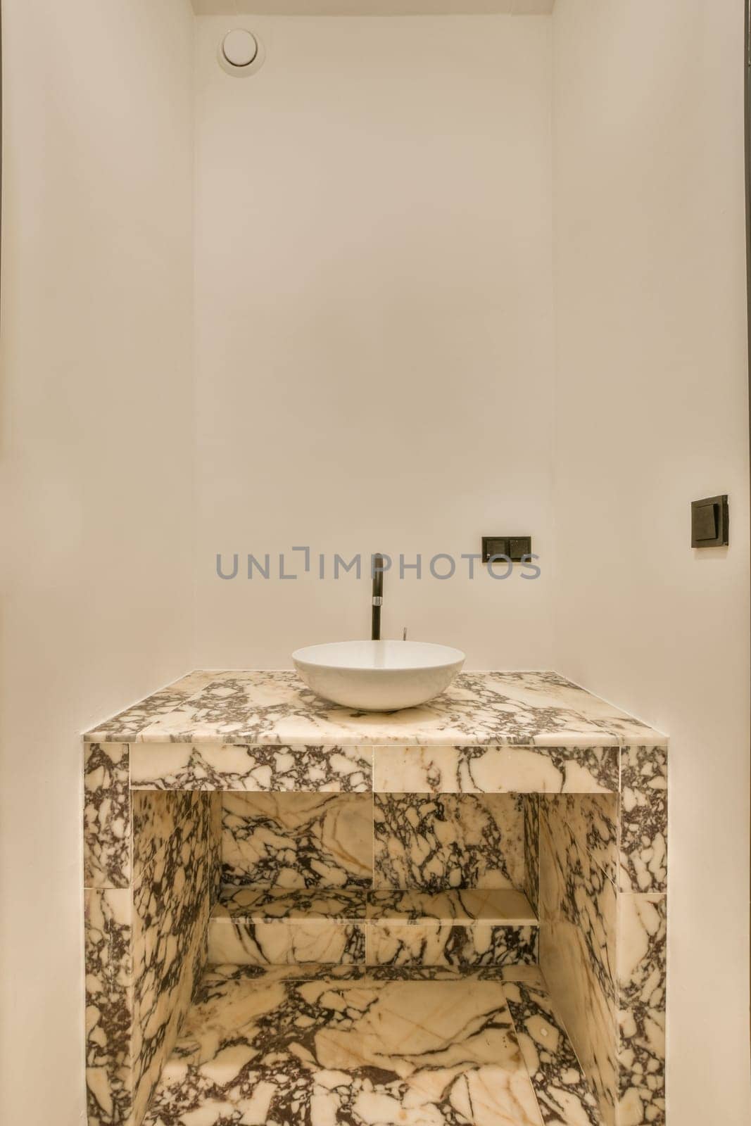 a bathroom with a sink and a marble counter top by casamedia