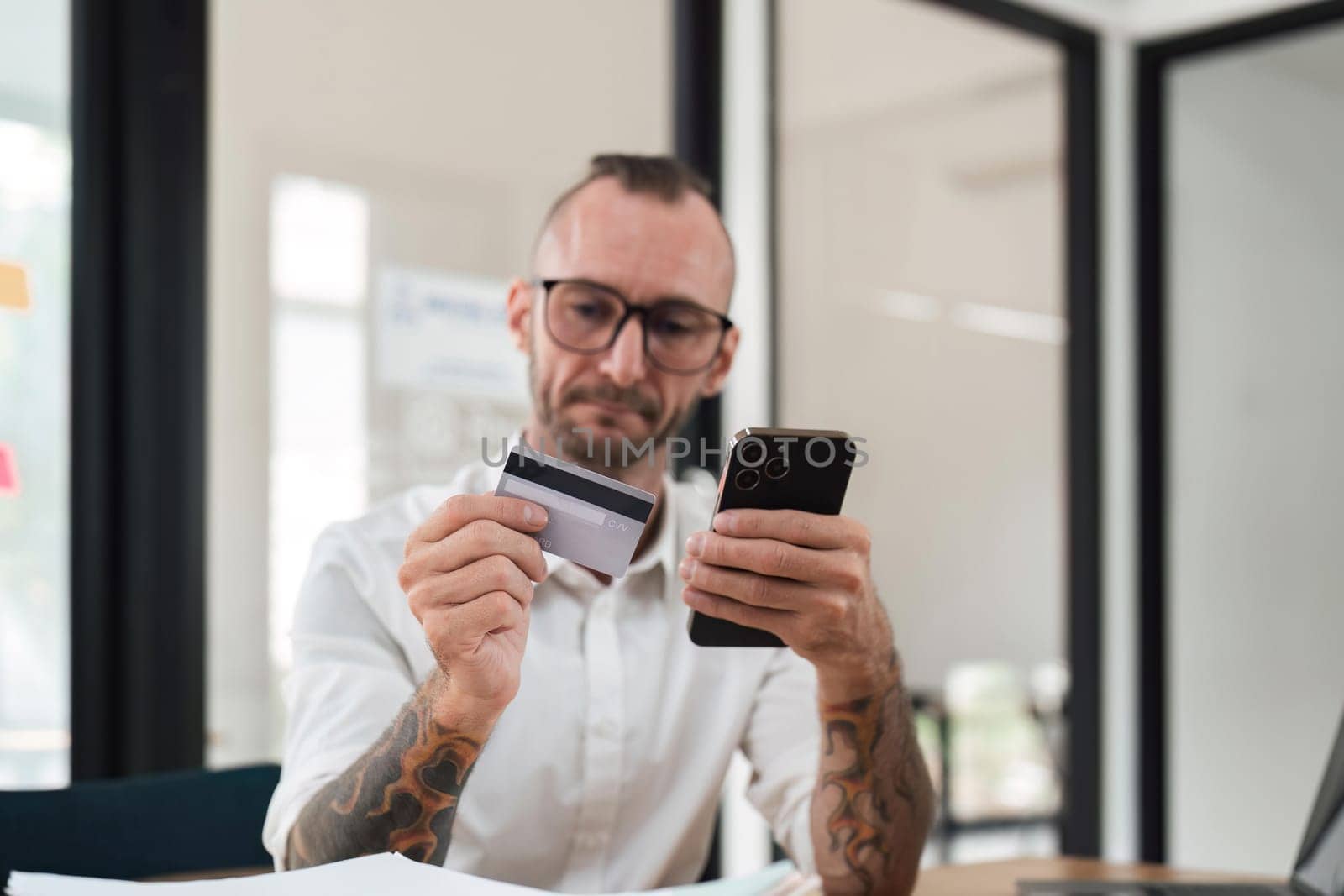 Man using mobile smart phone and credit card making online payment with mobile phone. Online shopping concept by nateemee