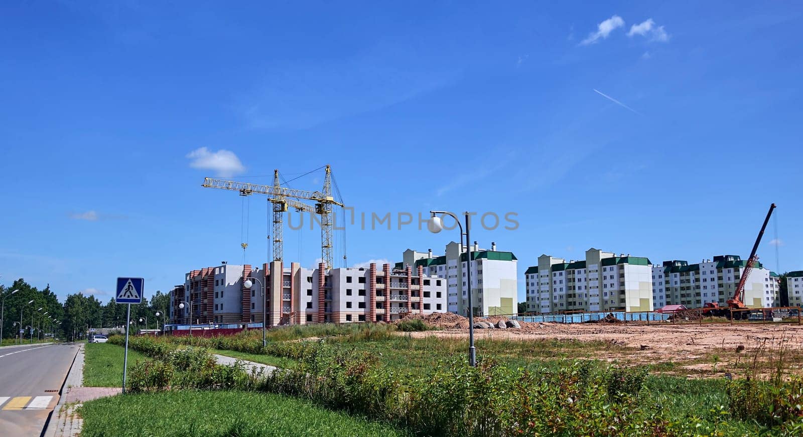 Panoramic view of construction sites and many cranes working in a new construction business.