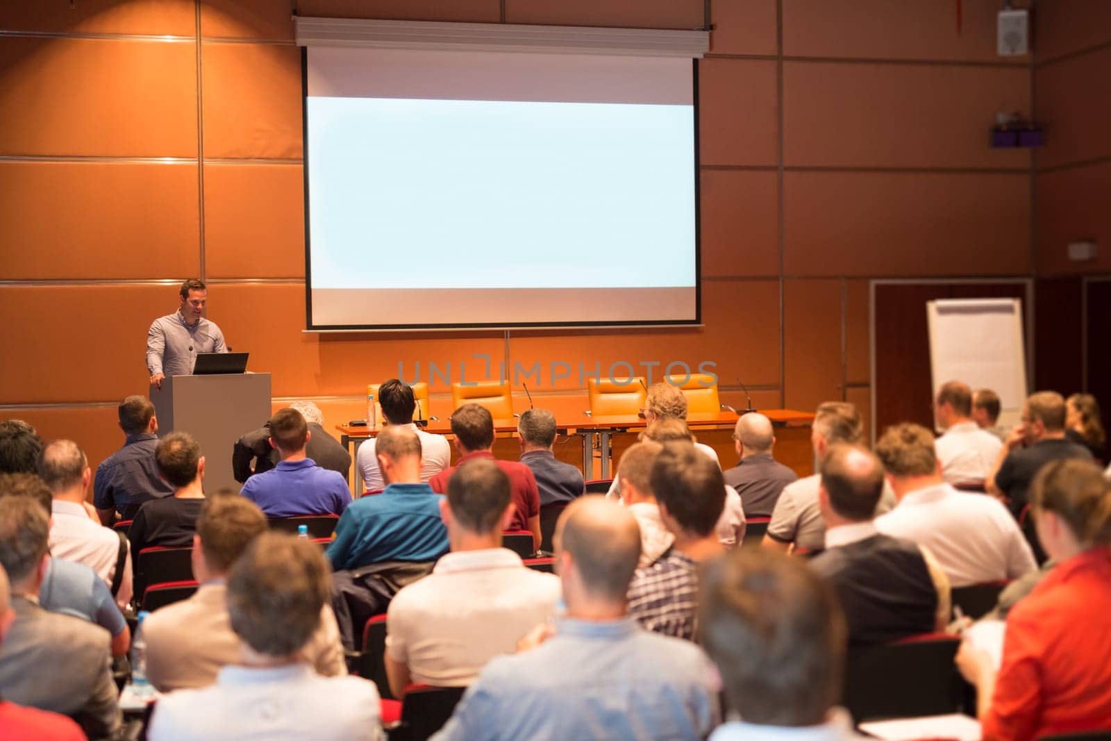 Business speaker giving a talk in conference hall. by kasto