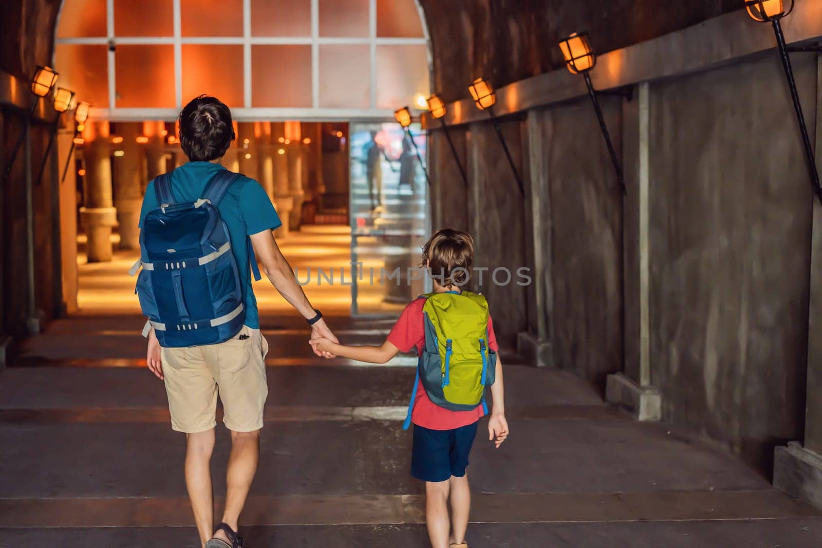 father and son tourists enjoying Beautiful cistern in Istanbul. Cistern - underground water reservoir build in 6th century, Istanbul, Turkey, Turkiye.