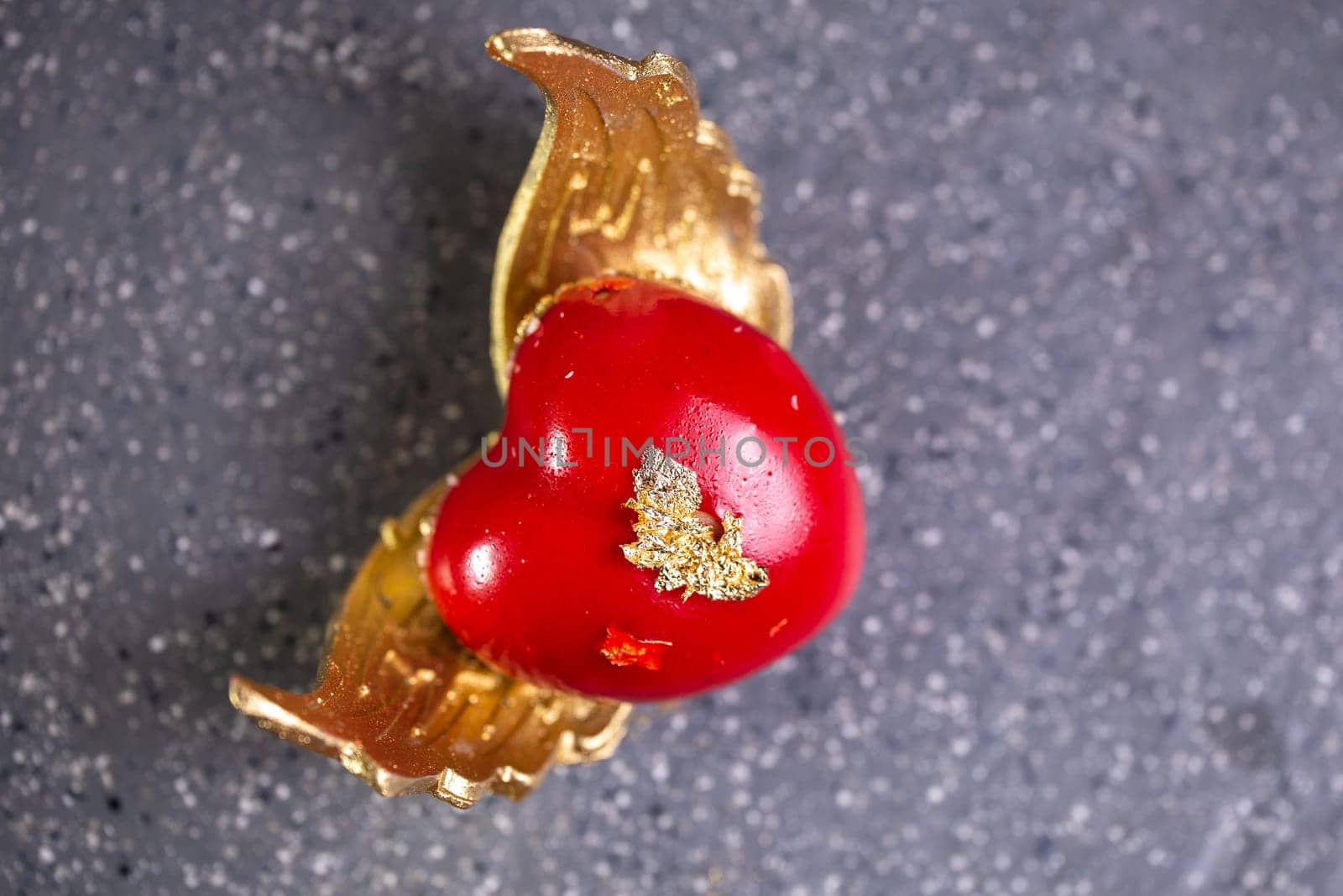 red dessert in the shape of a heart with wings.