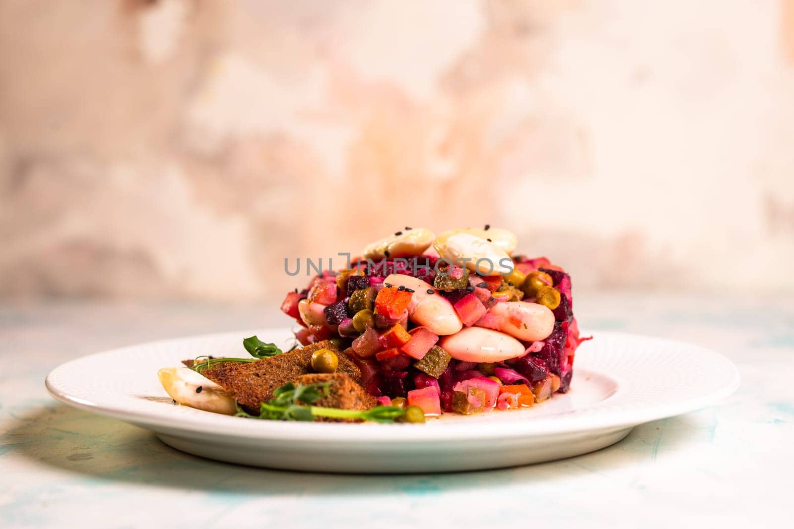 close-up salad vinaigrette with black bread on a plate by Pukhovskiy