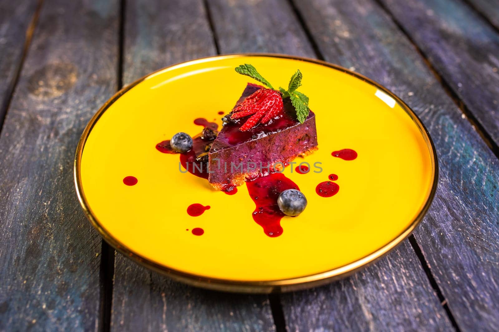 berry dessert with strawberries on a yellow plate. by Pukhovskiy