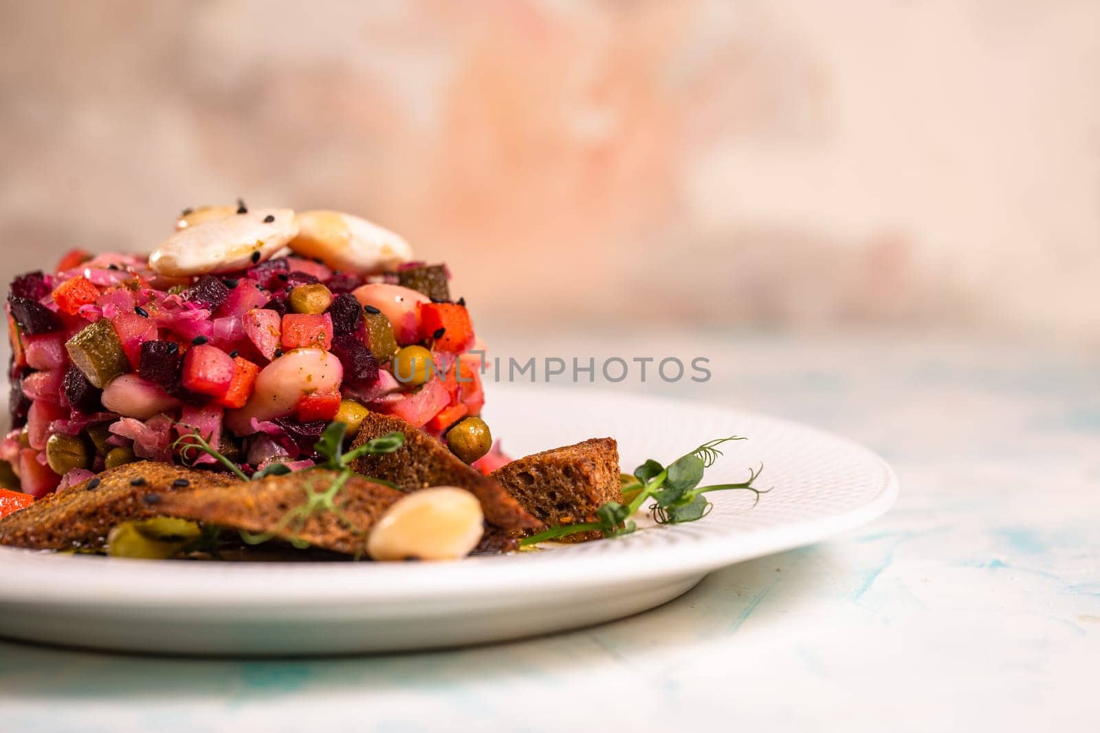 close-up salad vinaigrette with black bread on a plate.