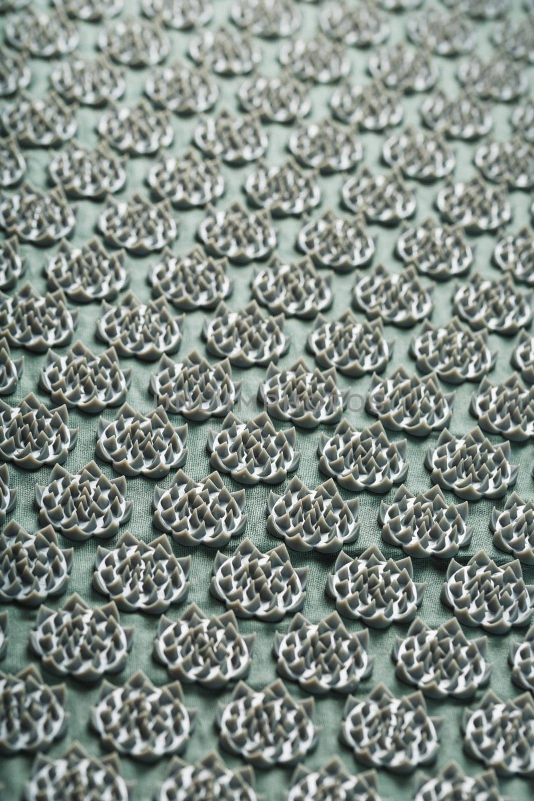 Massage mat with prickly spikes Kuznetsov applicator top view. On a gray background with free space