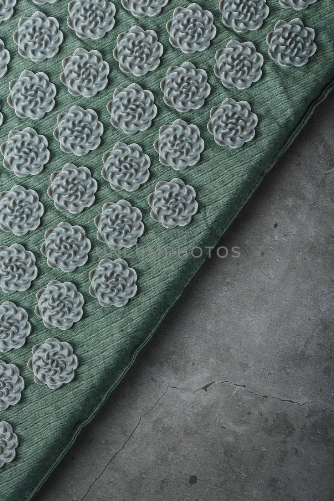Massage mat with prickly spikes Kuznetsov applicator top view. On a gray background with free space