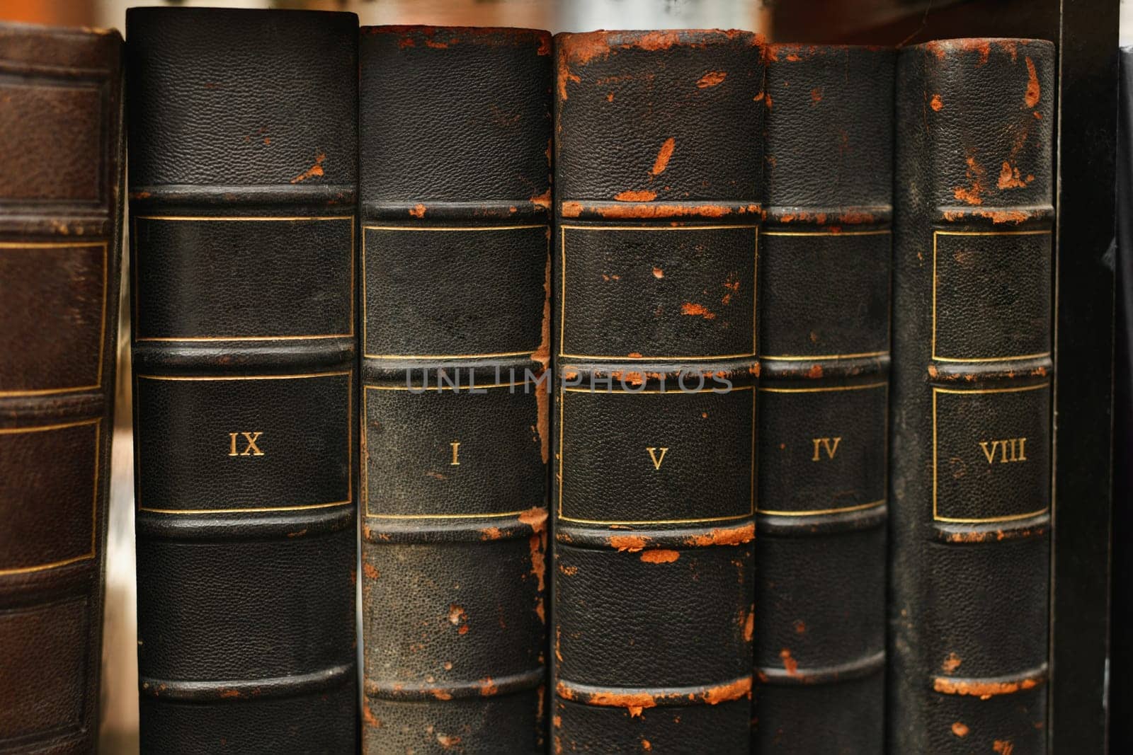 Old worn books on a shelf in the library's archives