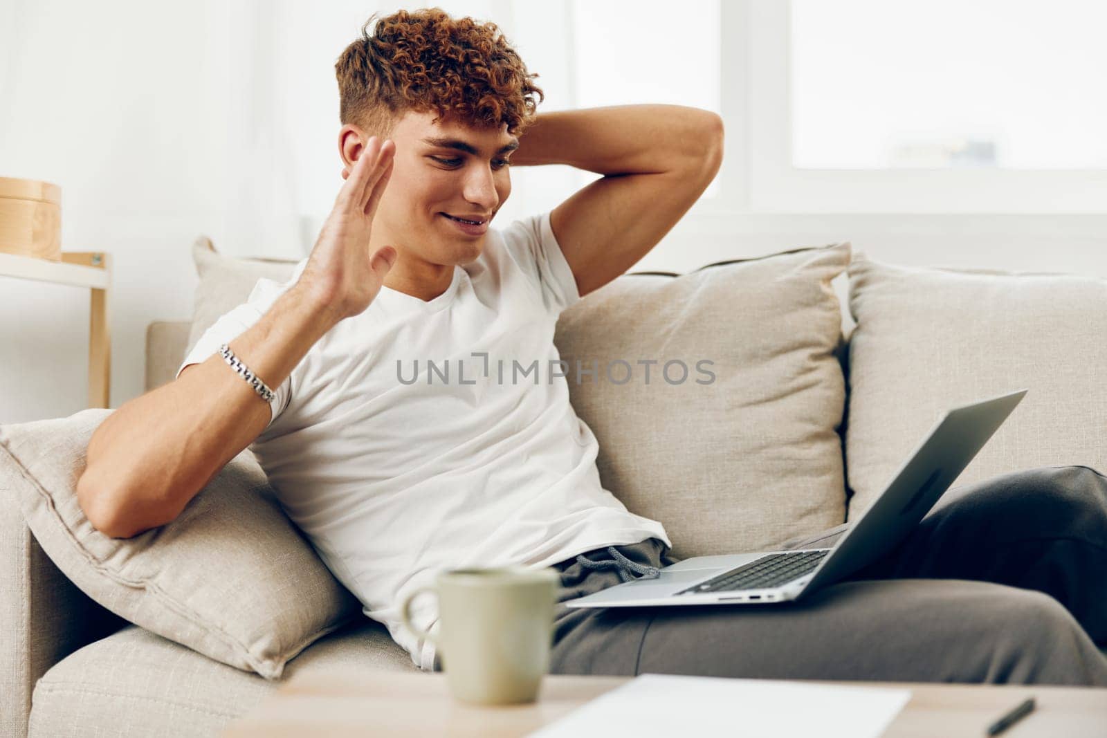 man interior job laptop internet caucasian cyberspace student couch technology sofa looking business person notebook computer lifestyle blissful laptop freelance cup