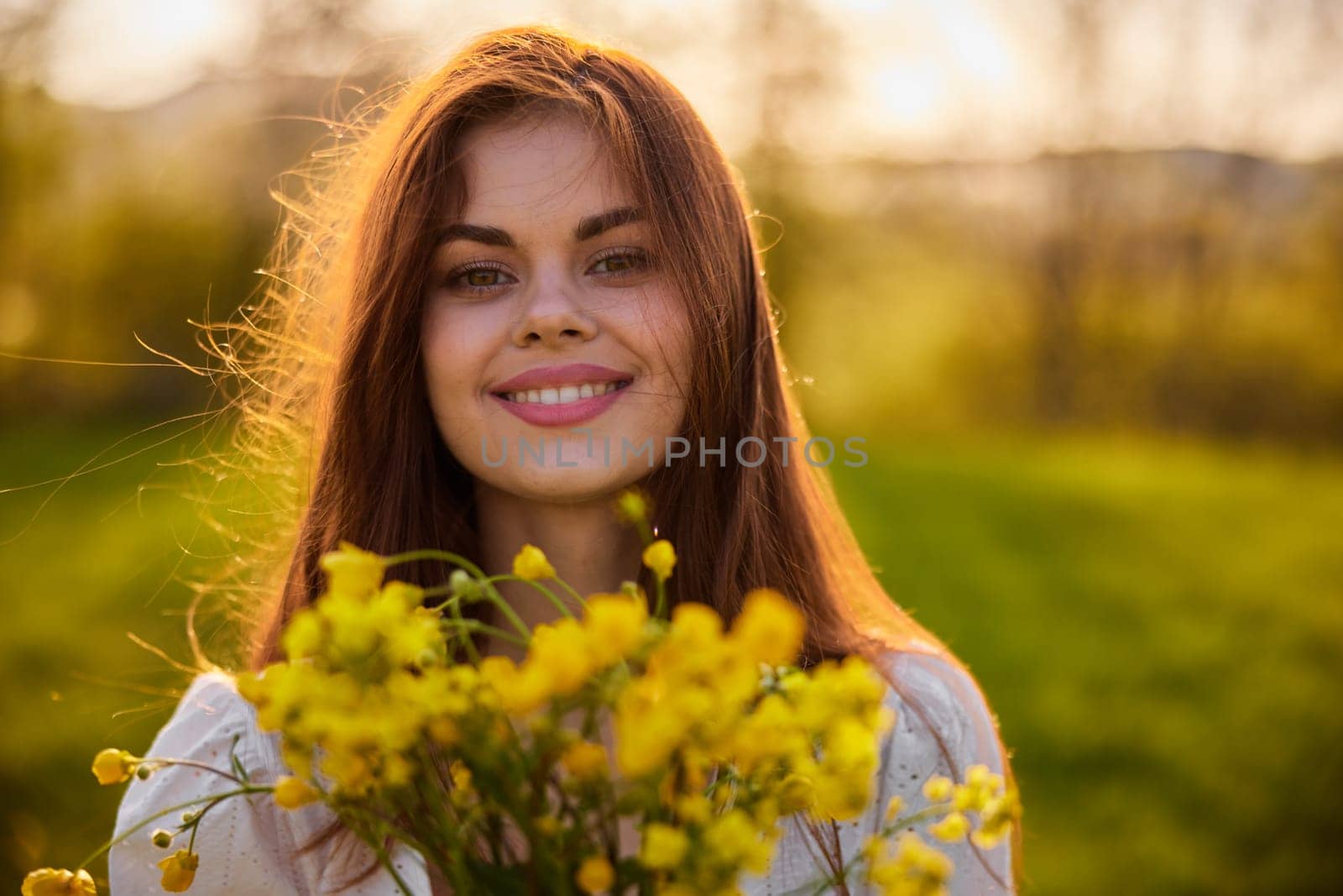 close portrait of a redhead woman smiling happily at the camera with a bouquet of yellow flowers. High quality photo