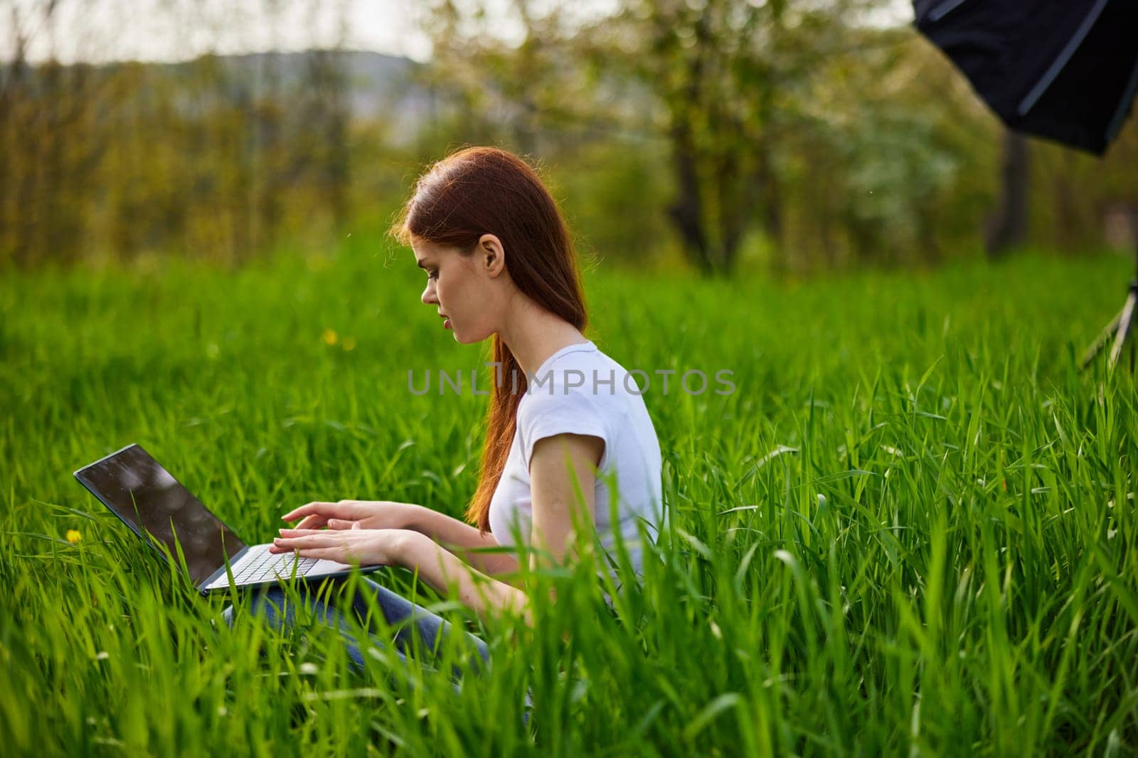 student with a laptop in the park working by Vichizh