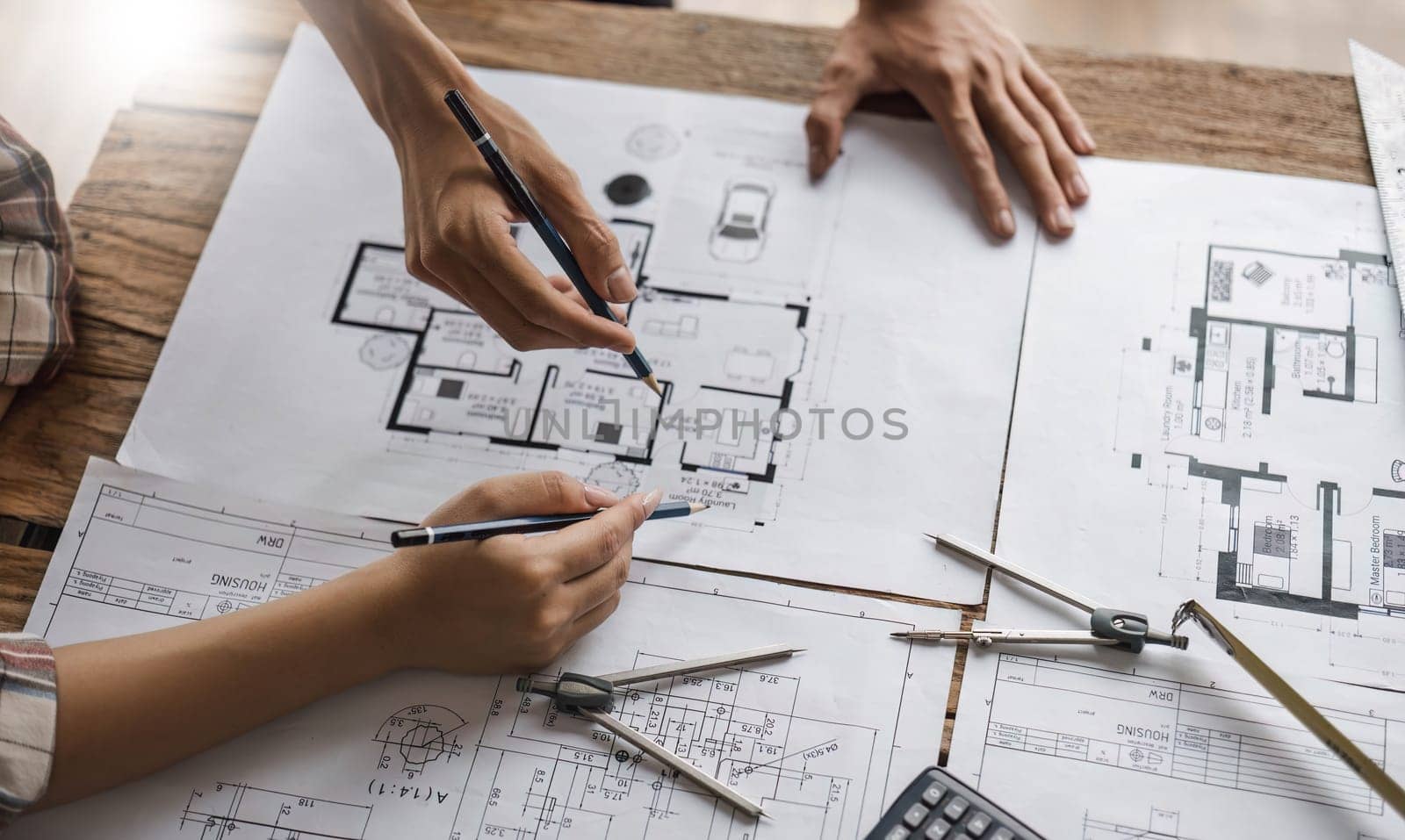 engineer people meeting working and pointing at a drawings in office for discussing. Engineering tools and construction concept...