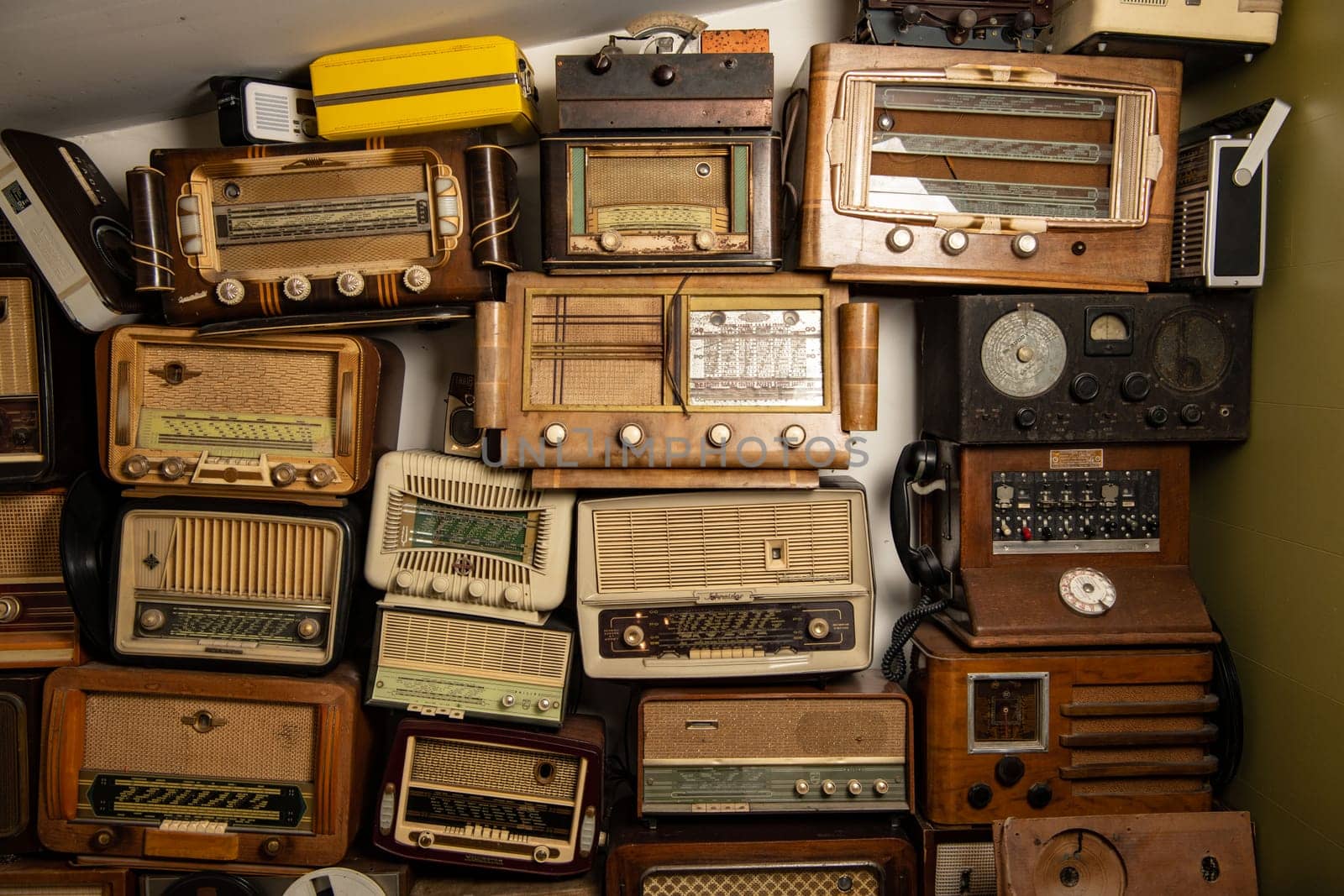 France, Paris, April-15-2023, Collection of retro radio and telephone receivers circa 1950. Listening to music. Vintage instagram old style filtered photo, High quality photo